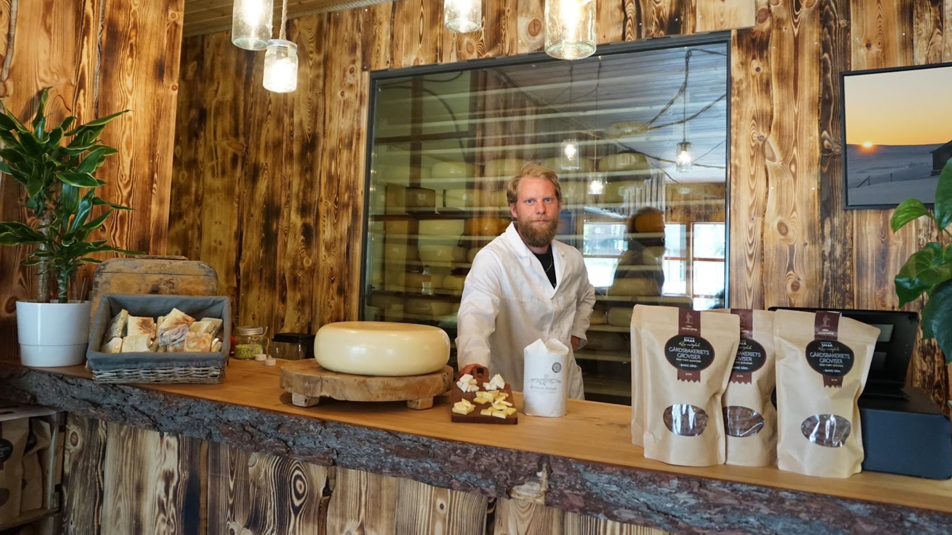 A man standing behind the counter inside the cheese factory Hol Ysteri in Hallingdal, Eastern Norway