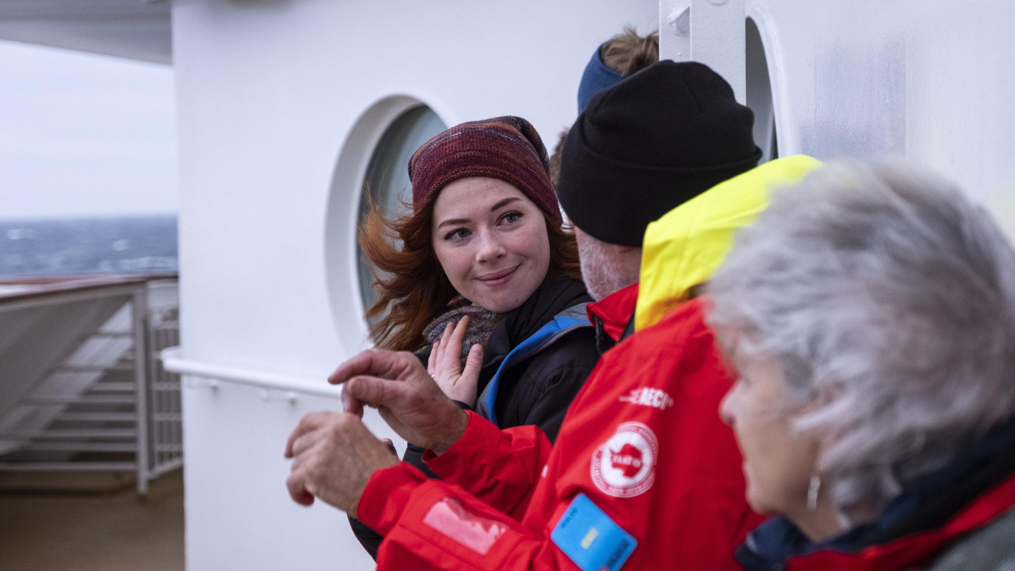 People enjoying the view out on deck on board MS Maud