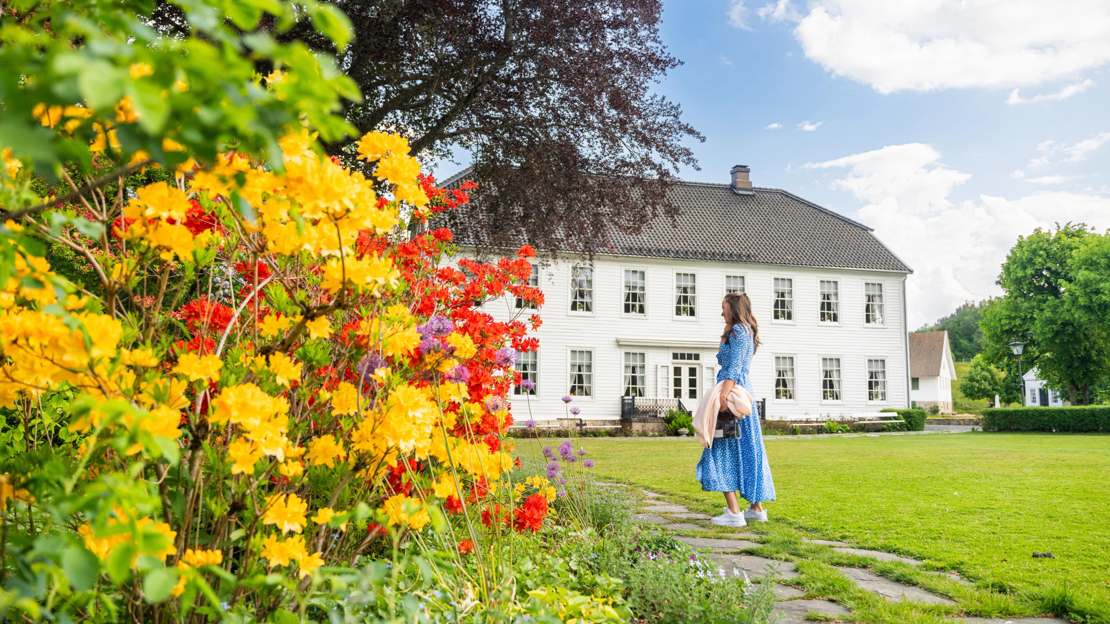 A woman in the garden of the Boen Gård farm outside Kristiansand.