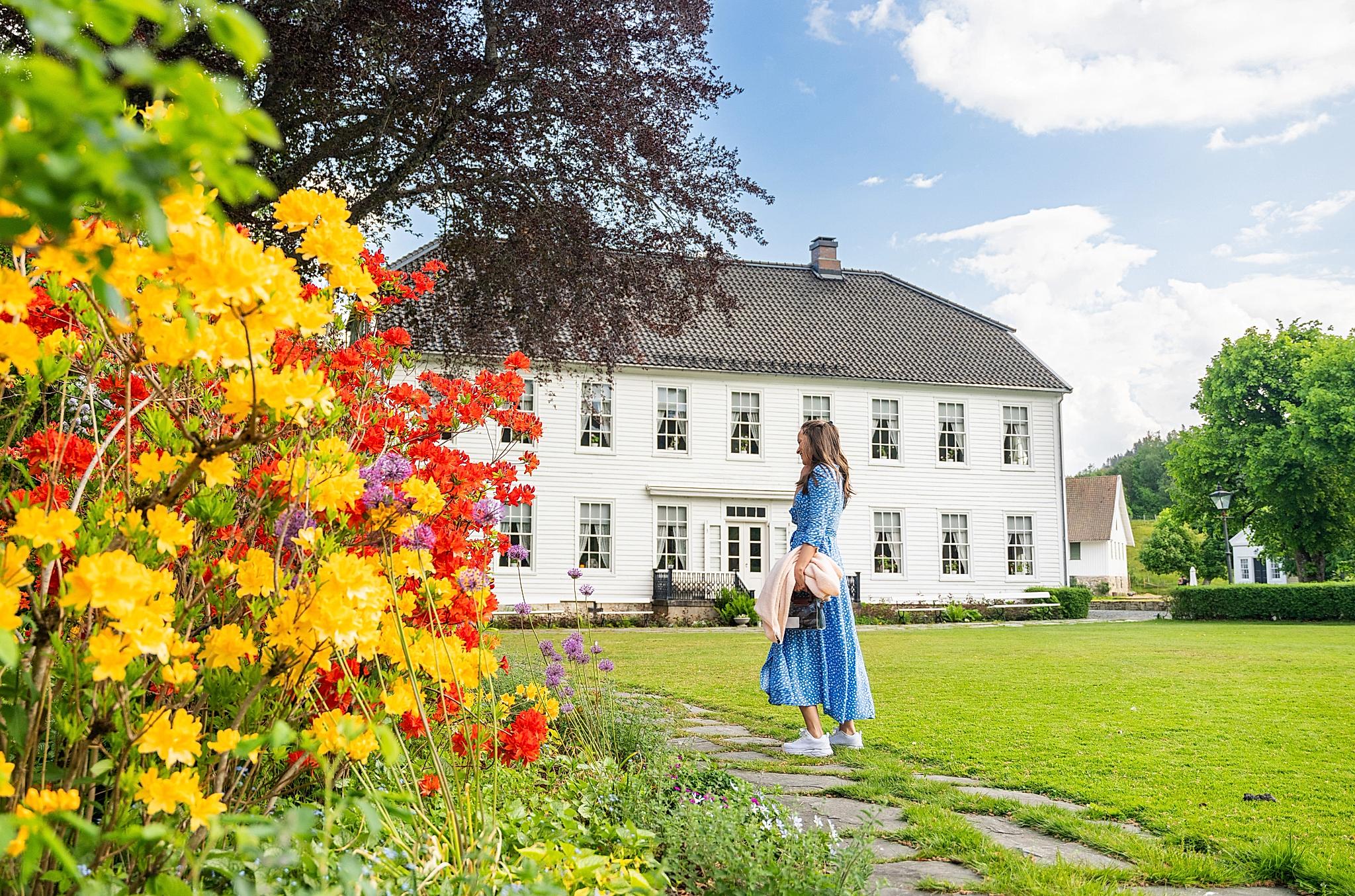 A woman in the garden of the Boen Gård farm outside Kristiansand.