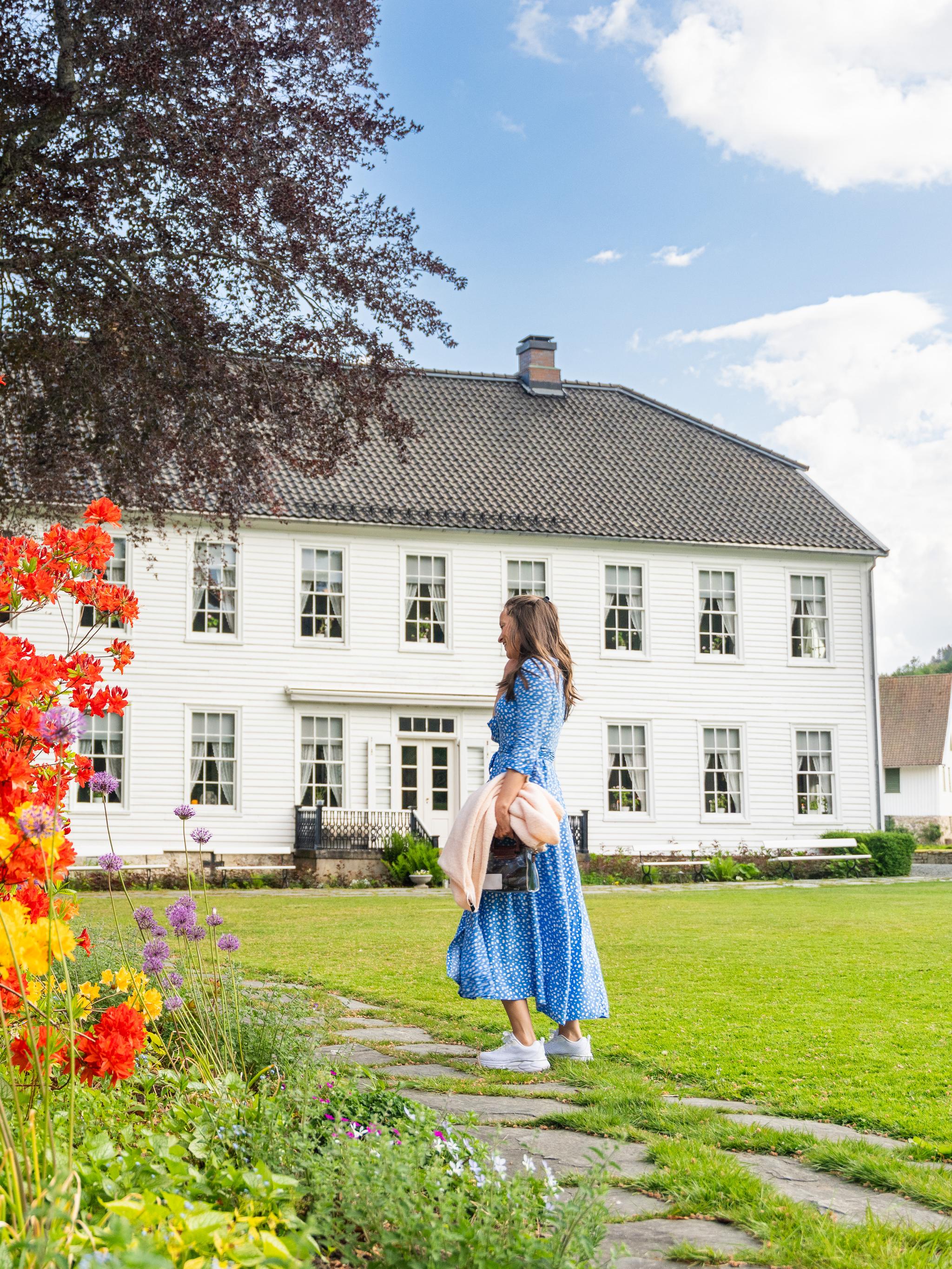 A woman in the garden of the Boen Gård farm outside Kristiansand.