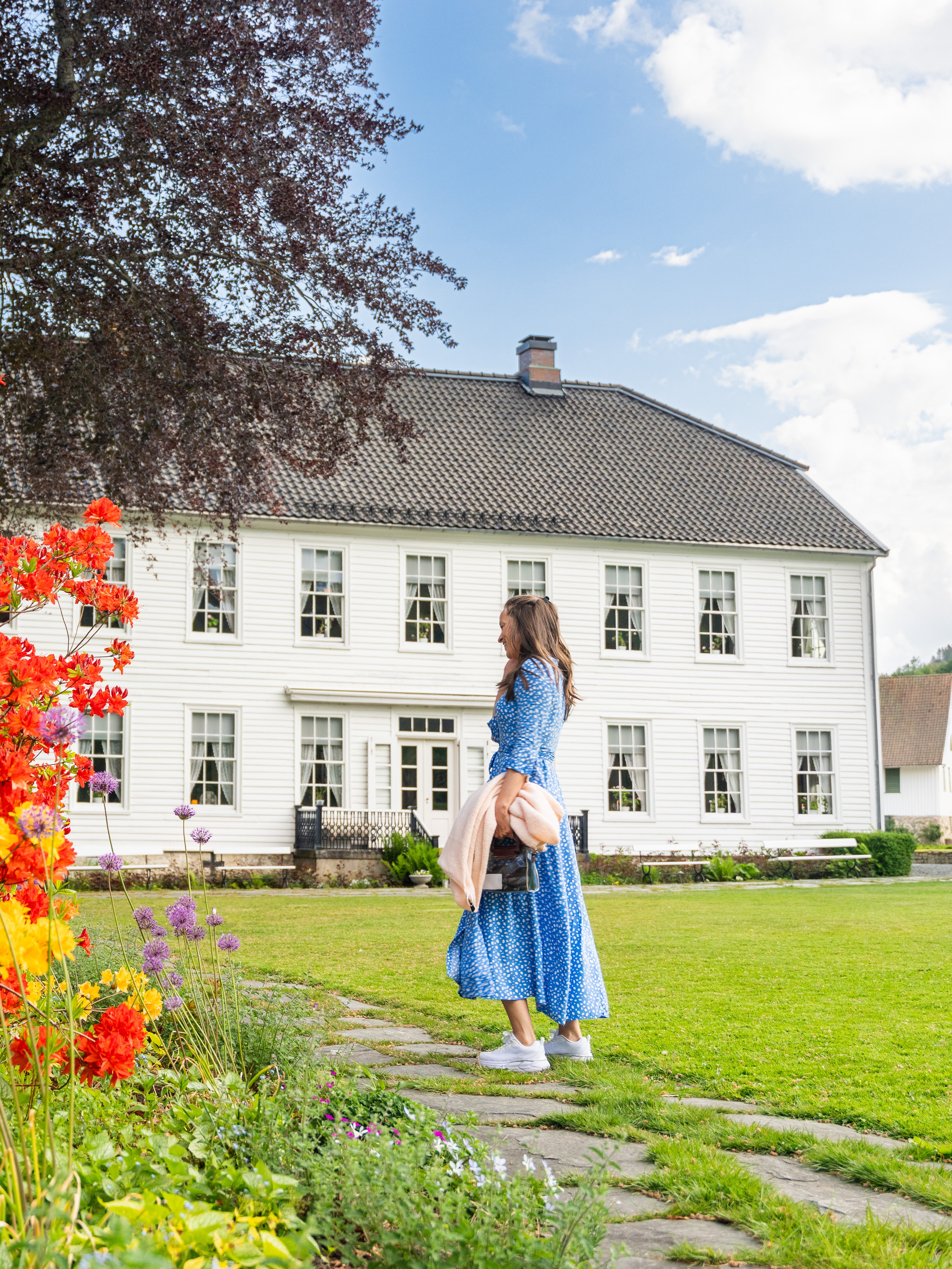 A woman in the garden of the Boen Gård farm outside Kristiansand.