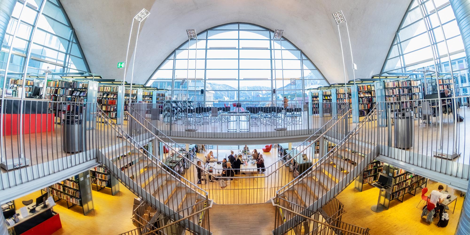 People reading Norwegian literature in Tromsø Library and City Archives