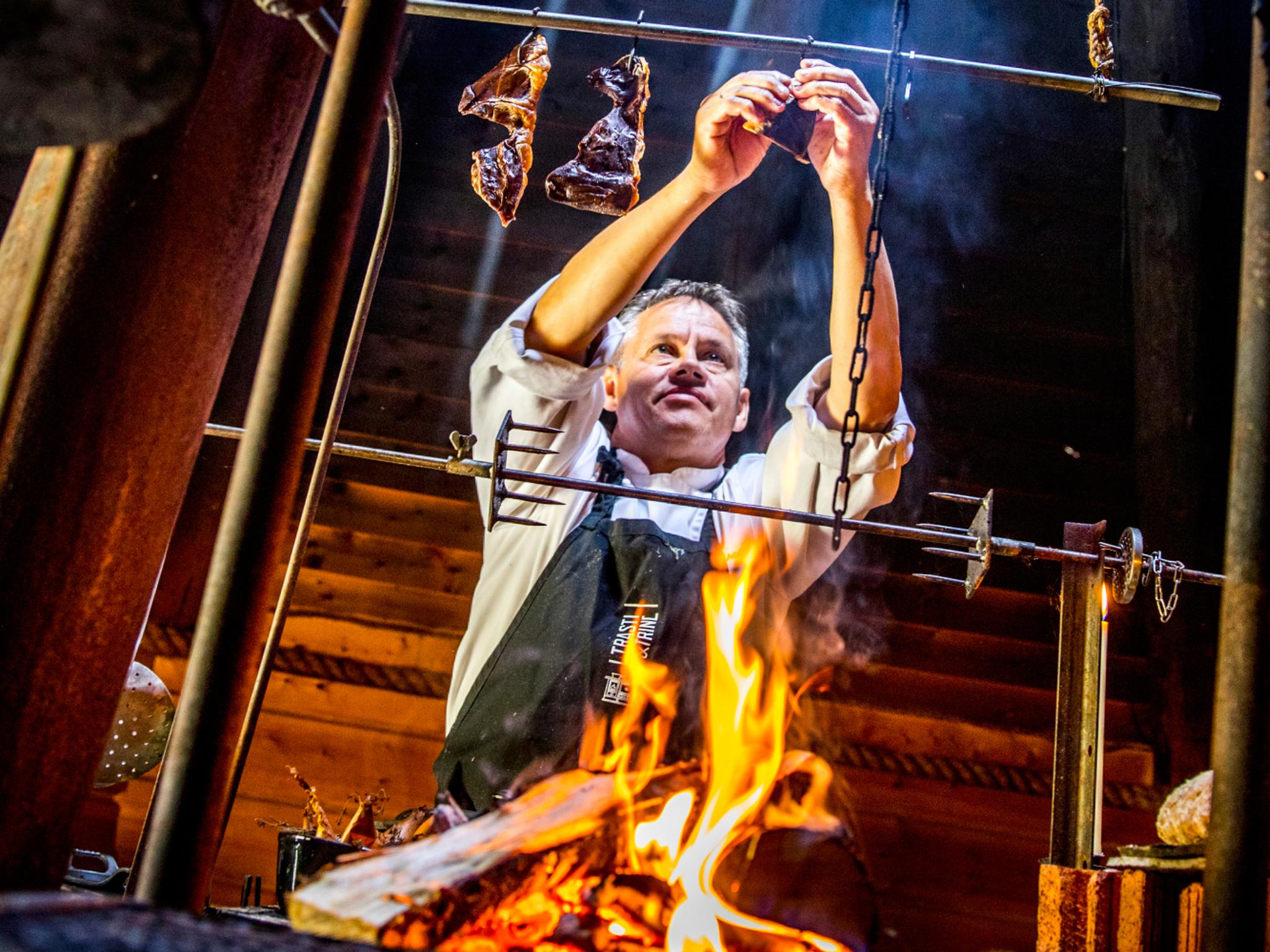 Johnny Trasti cooking over a bonfire