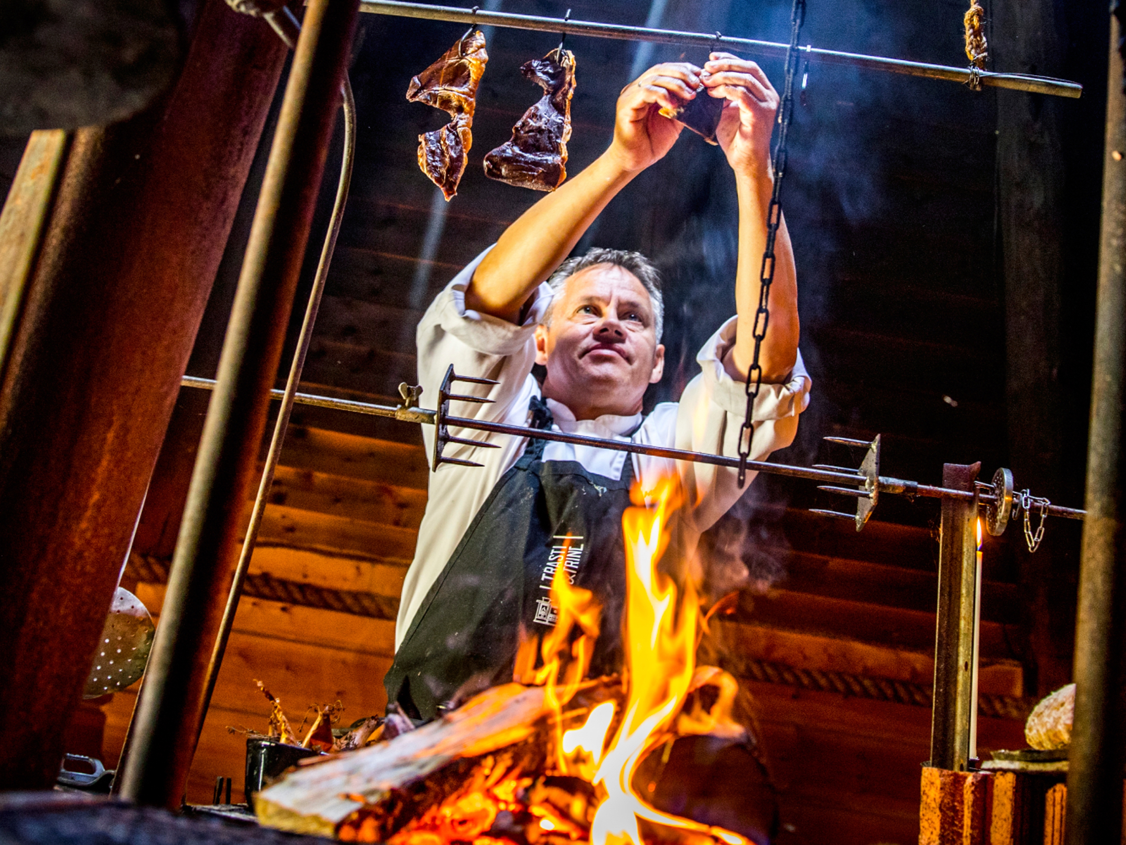 Johnny Trasti cooking over a bonfire