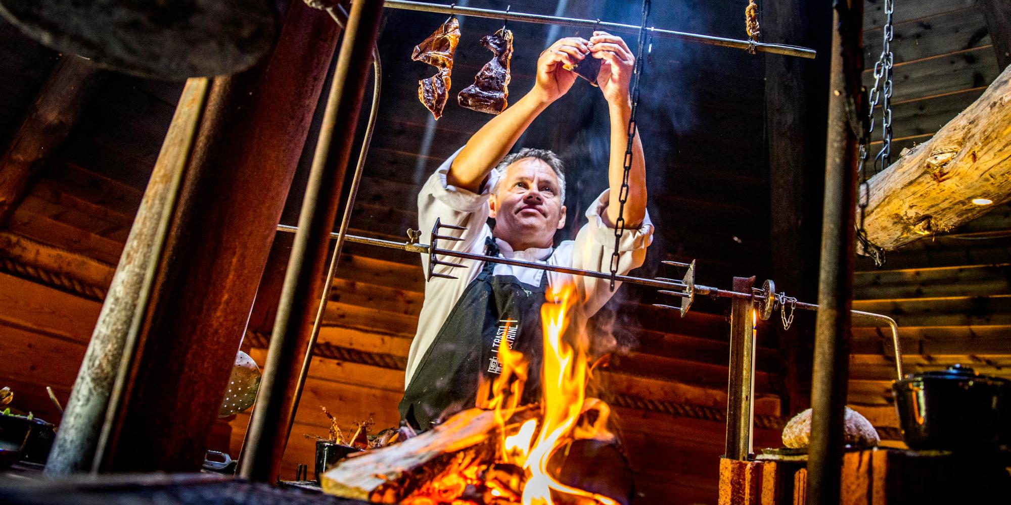 Johnny Trasti cooking over a bonfire