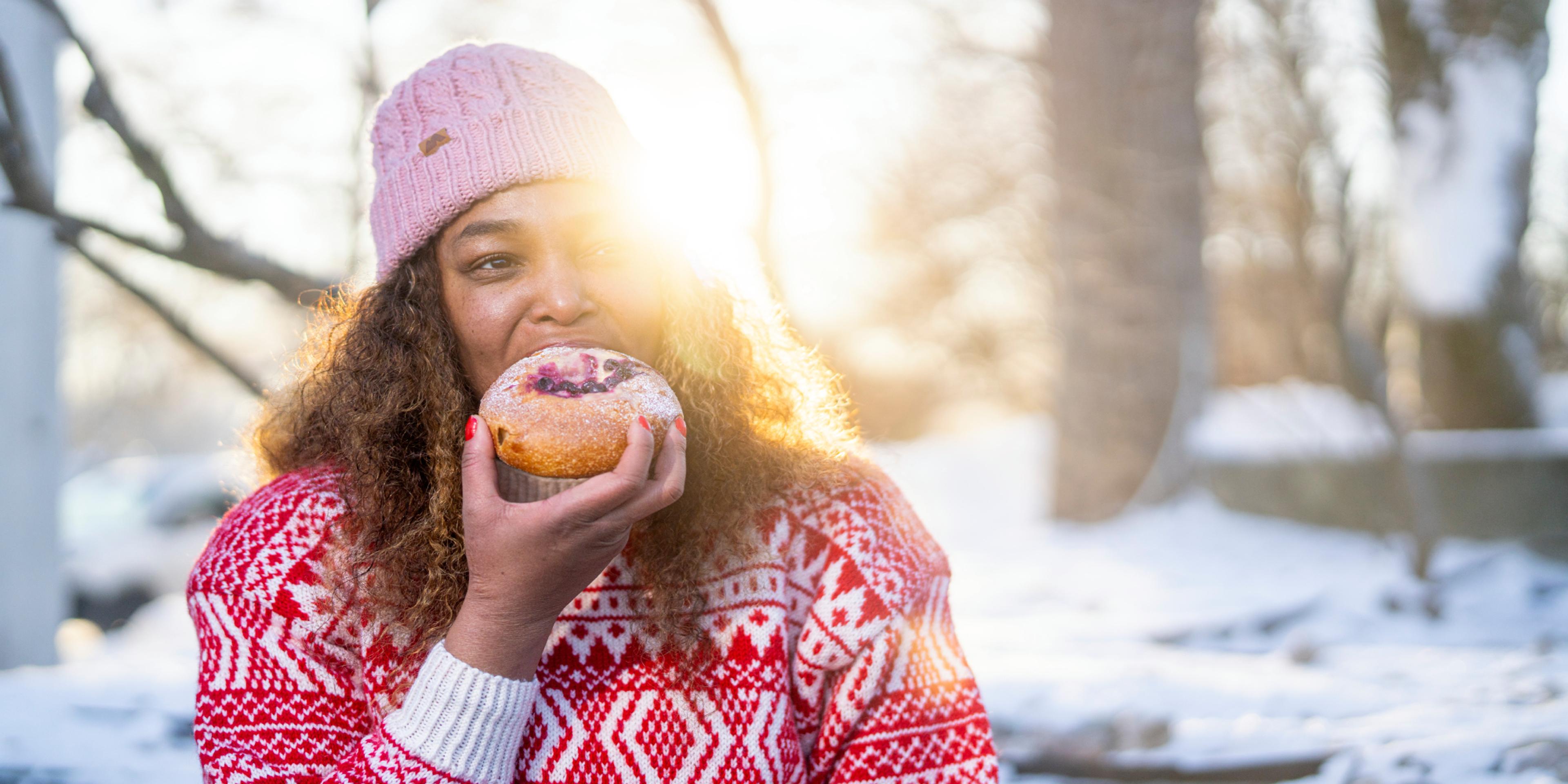Woman eating bun at the Anne på Landet café, in Frognerparken