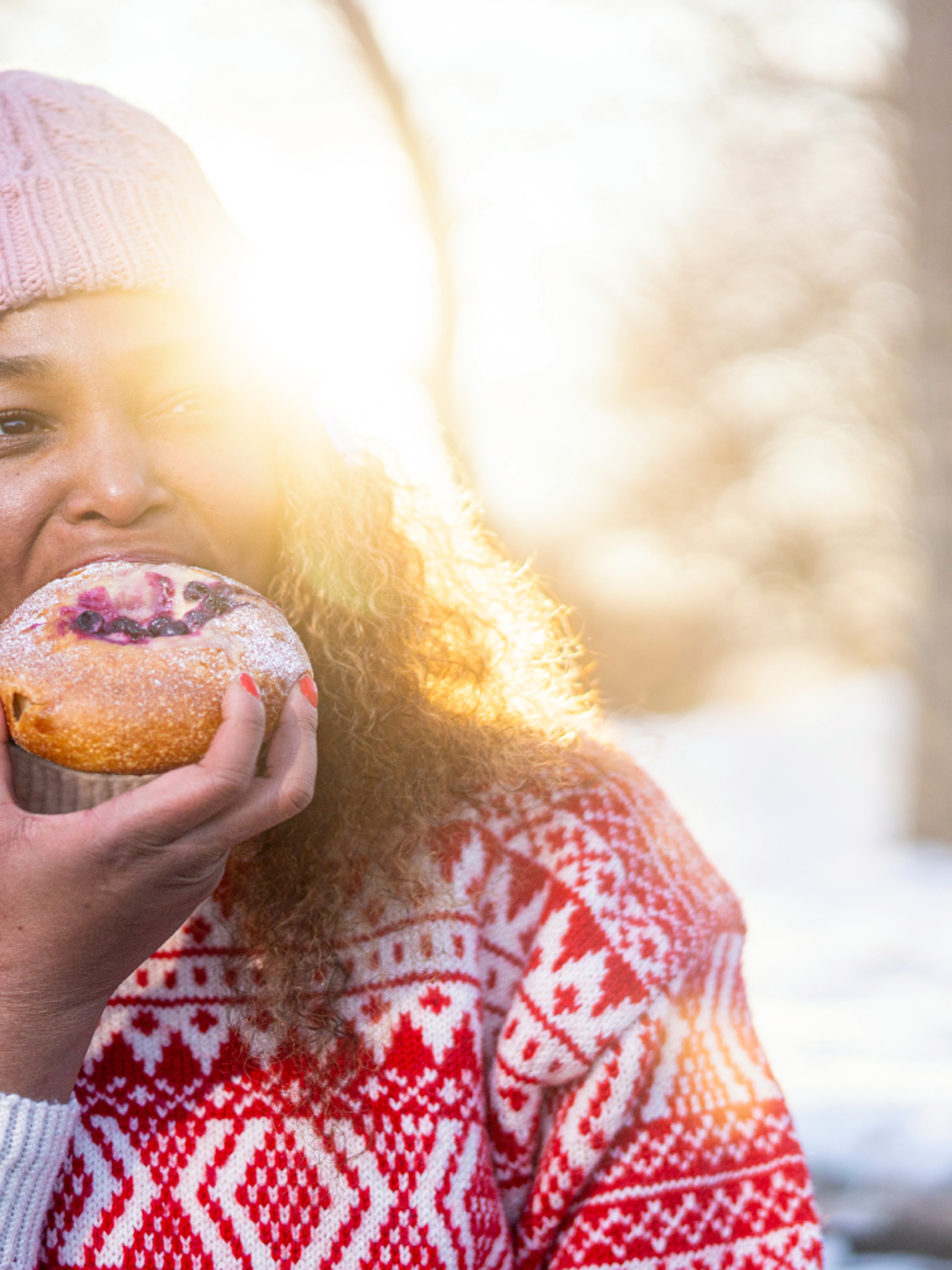 Woman eating bun at the Anne på Landet café, in Frognerparken