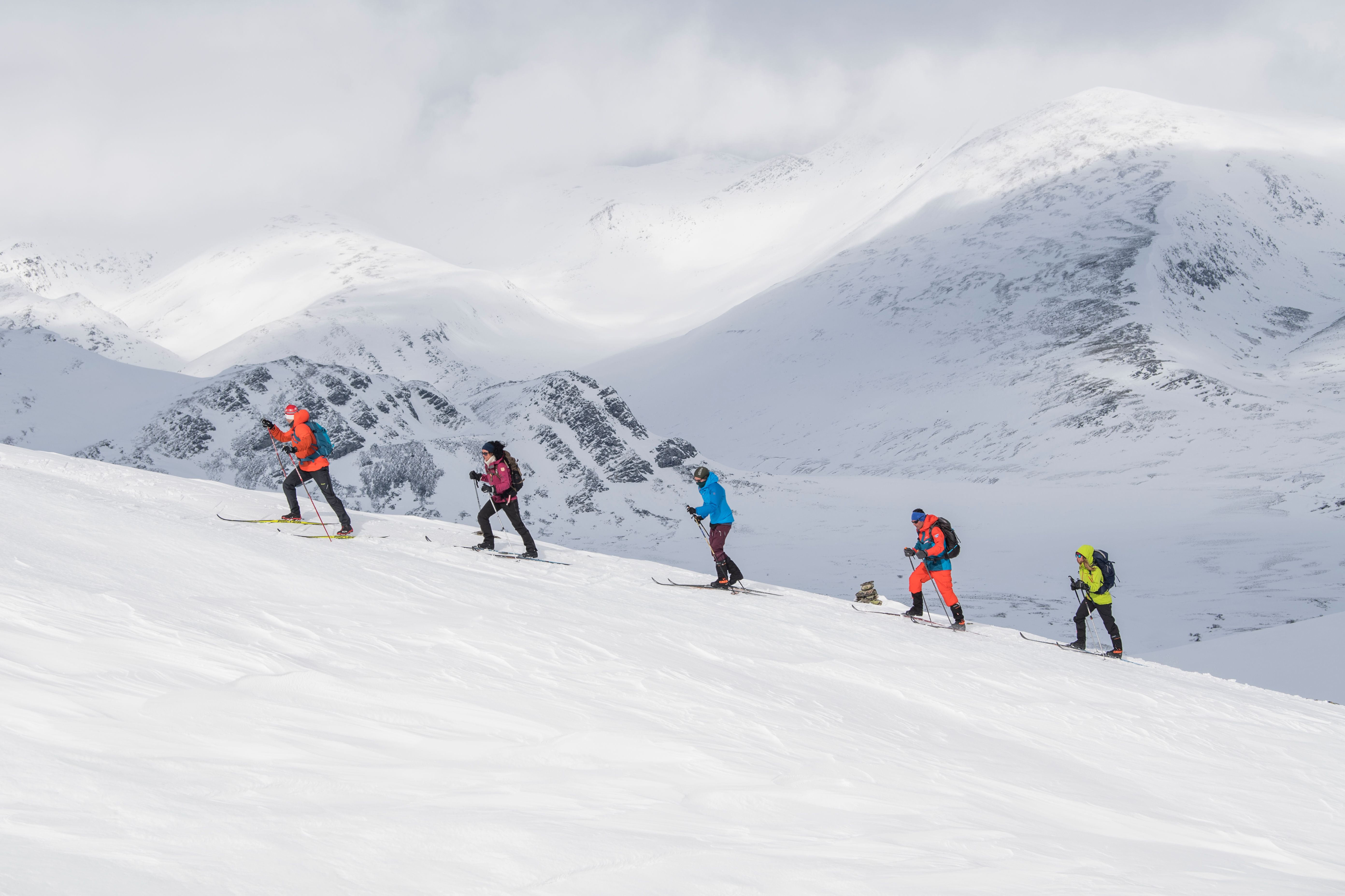 A group of people cross-country skiing up Høvringen in Rondane, Eastern Norway.