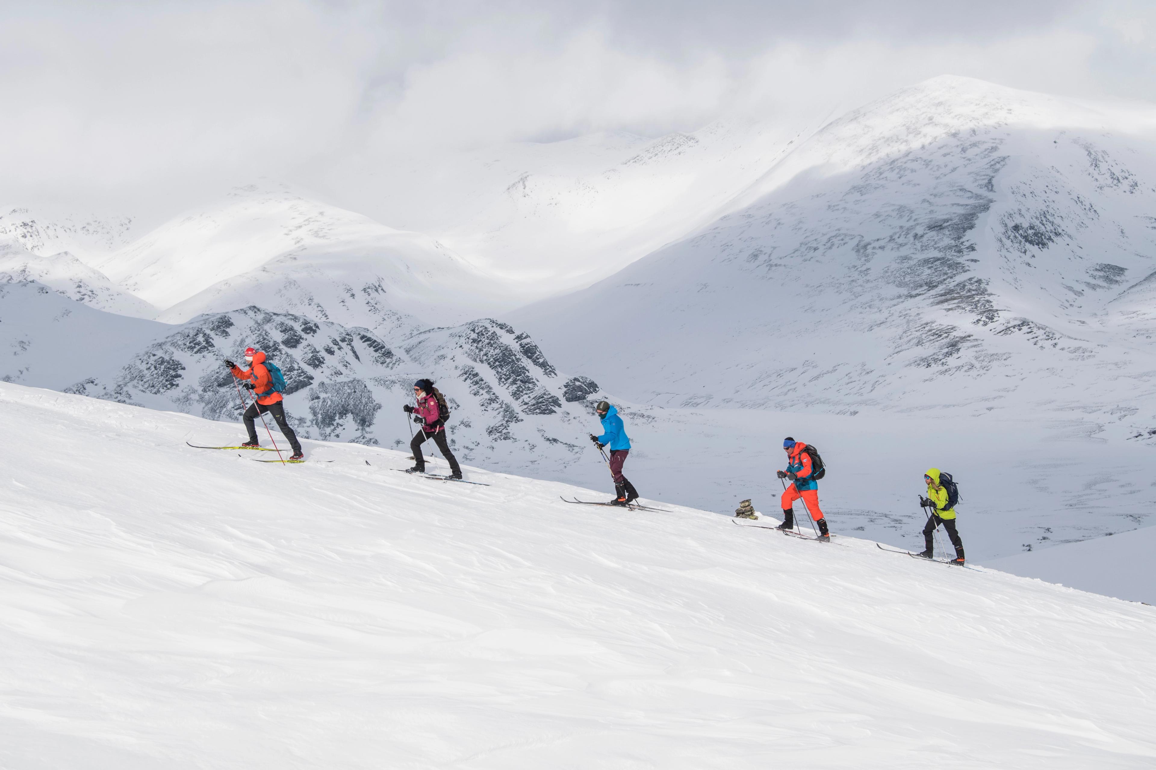 A group of people cross-country skiing up Høvringen in Rondane, Eastern Norway.