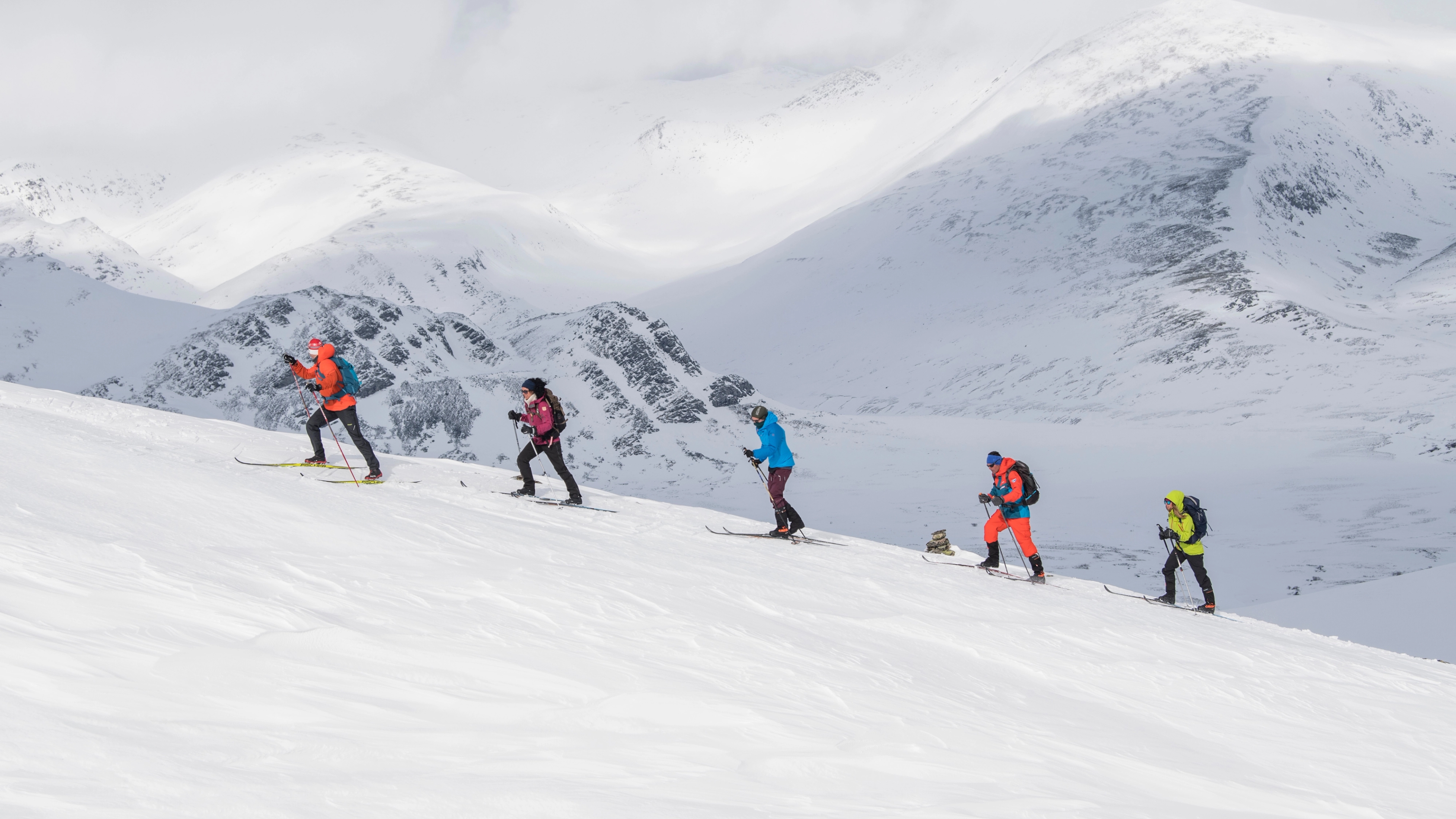 A group of people cross-country skiing up Høvringen in Rondane, Eastern Norway.