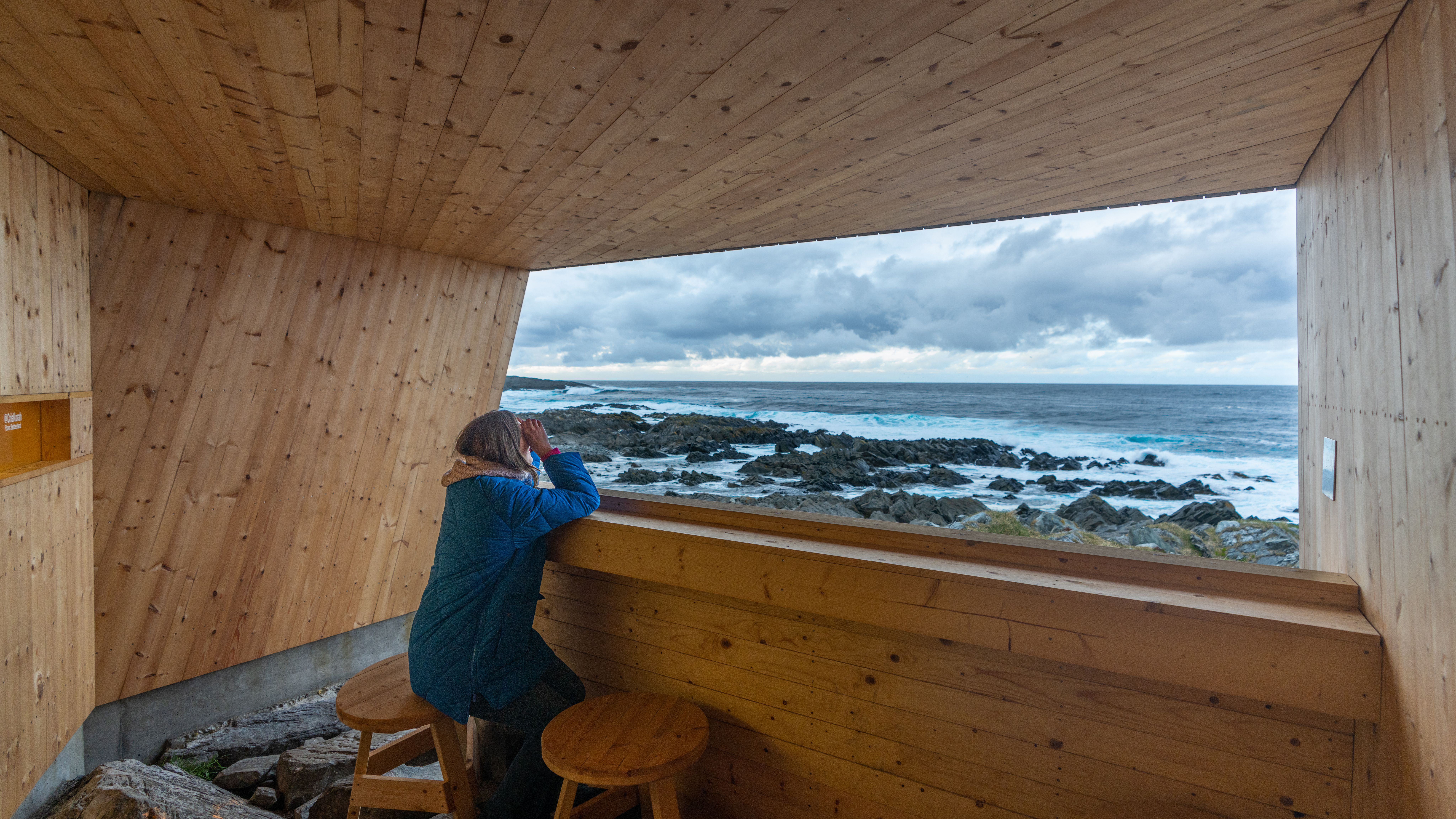 A woman in a birdwatching hide made by Biotope in Hamningberg, Varanger, Northern Norway