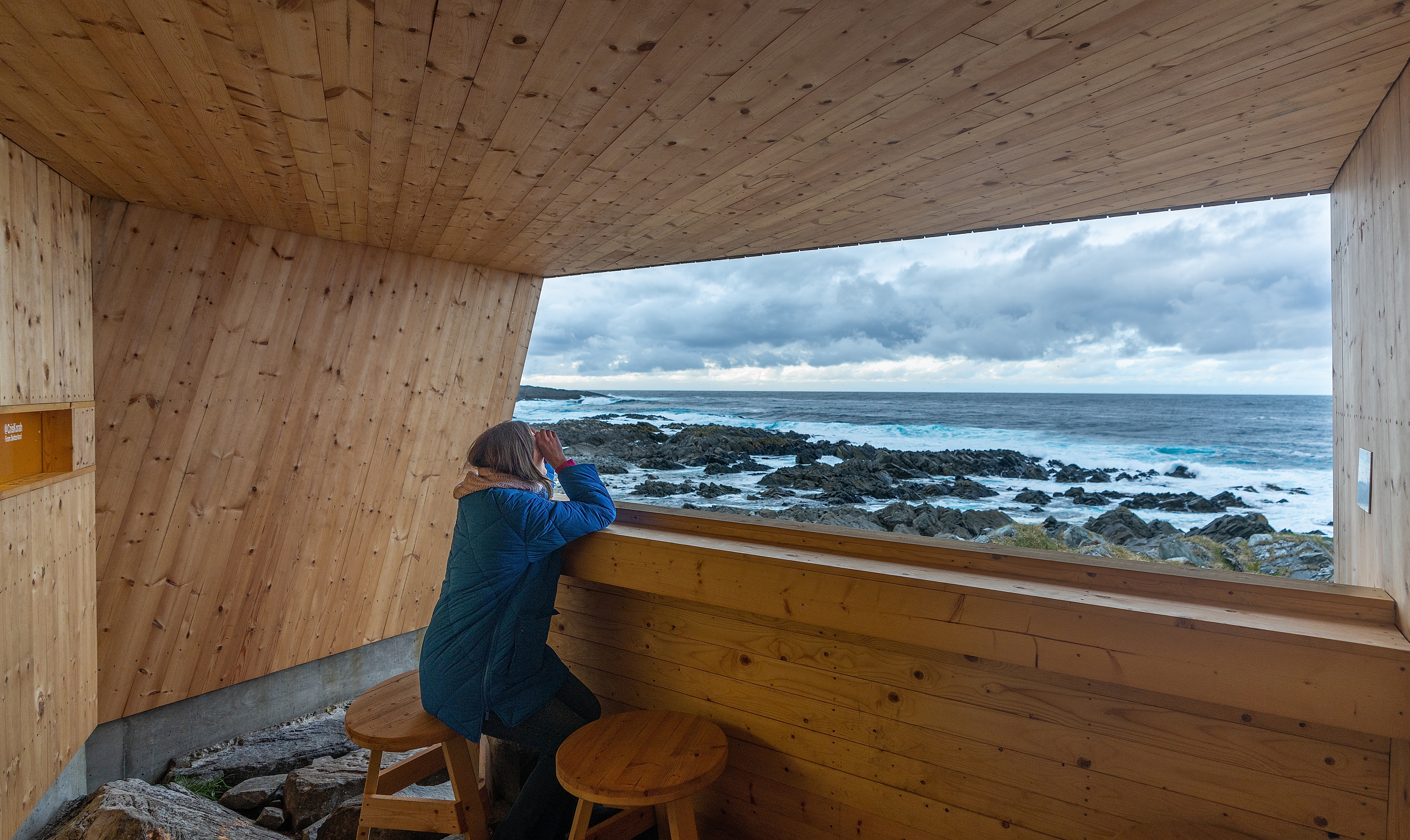 A woman in a birdwatching hide made by Biotope in Hamningberg, Varanger, Northern Norway