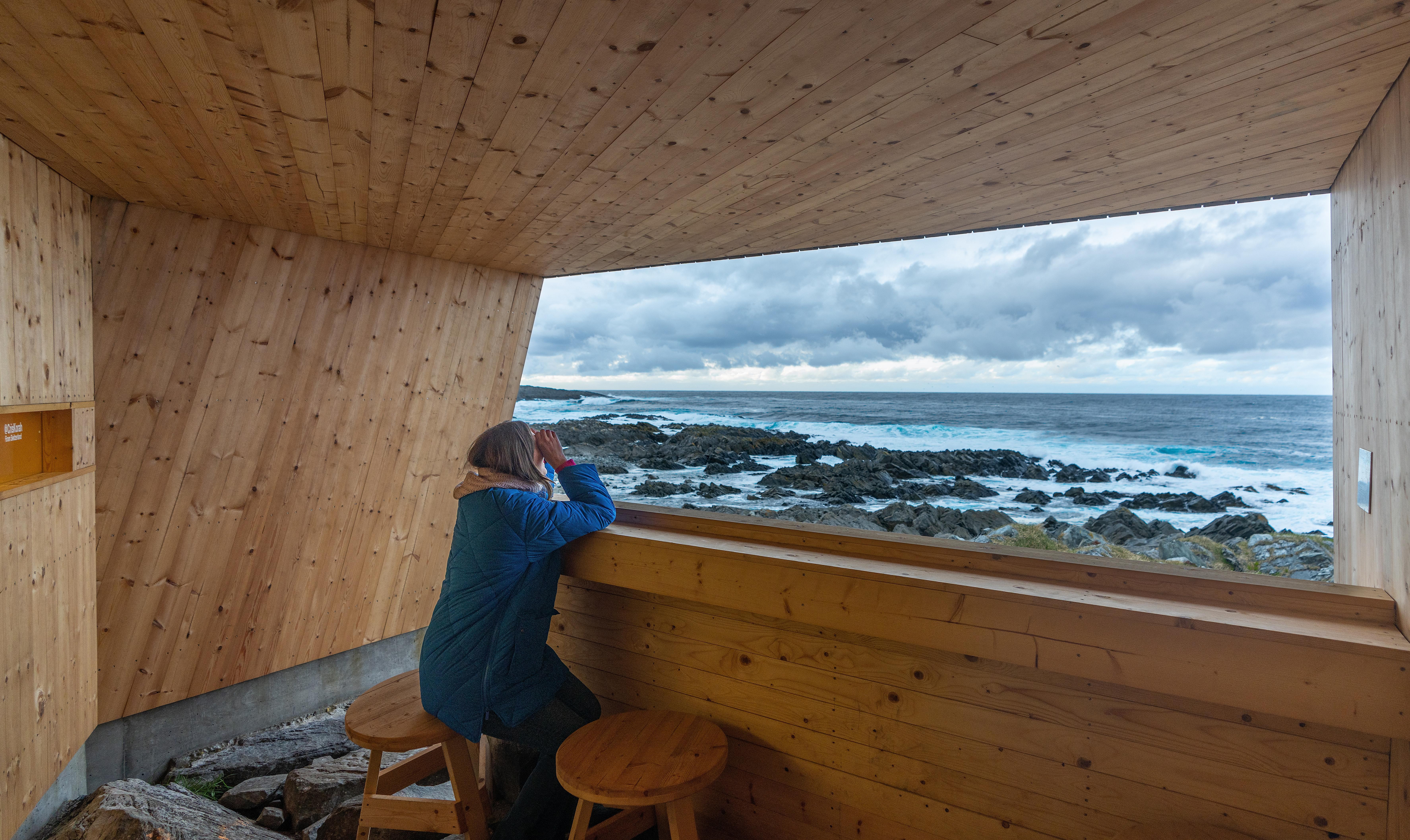 A woman in a birdwatching hide made by Biotope in Hamningberg, Varanger, Northern Norway