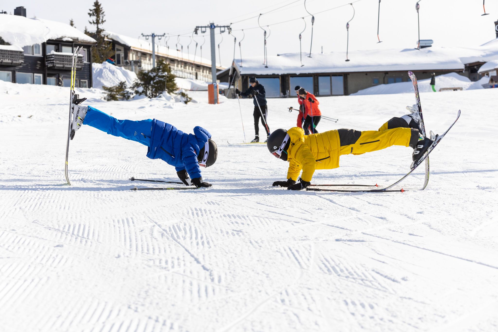 Kids playing with skis in the slopes