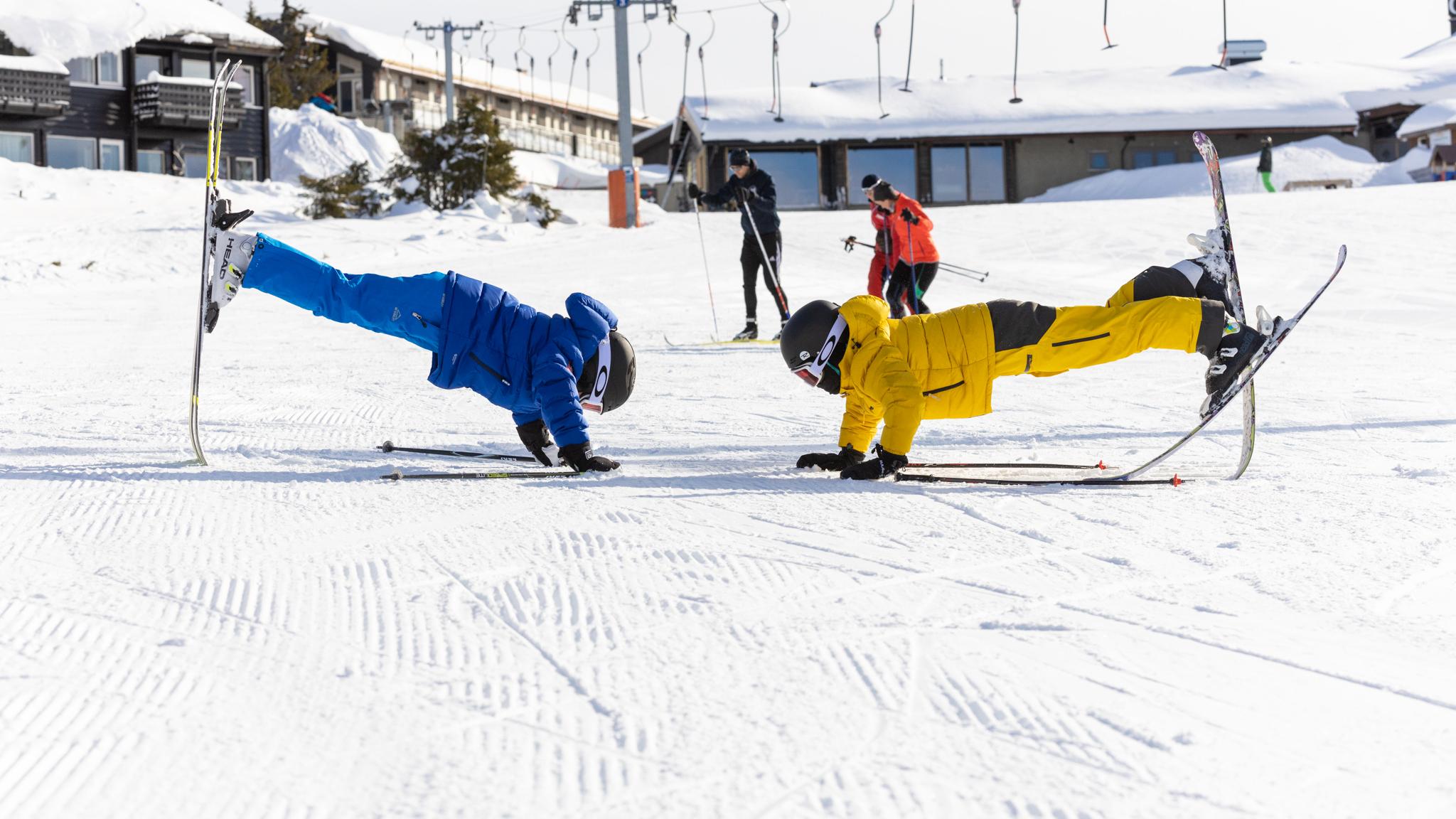 Kids playing with skis in the slopes