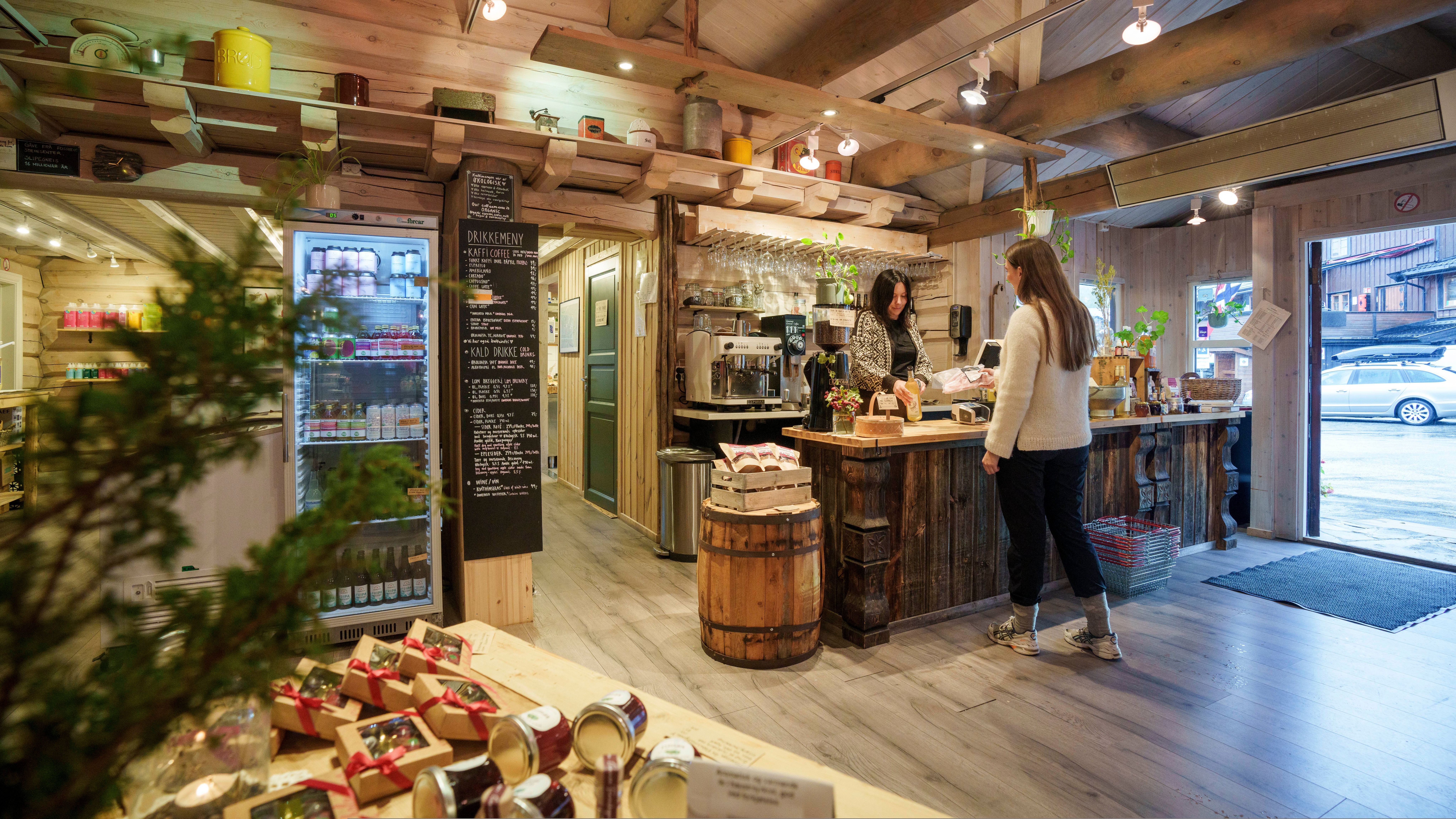A woman buying local products in a food shop.