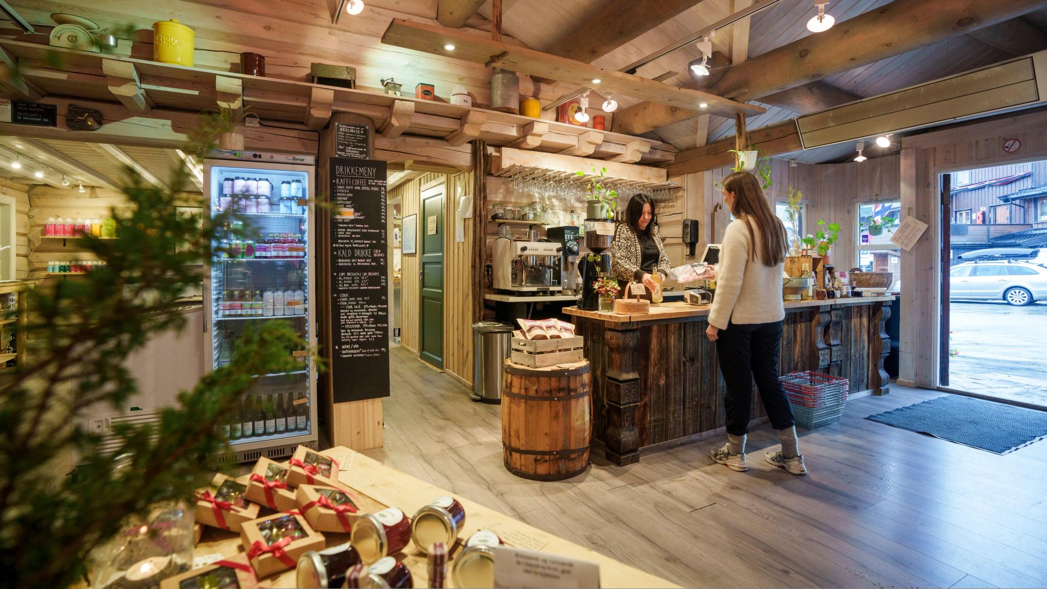 A woman buying local products in a food shop.