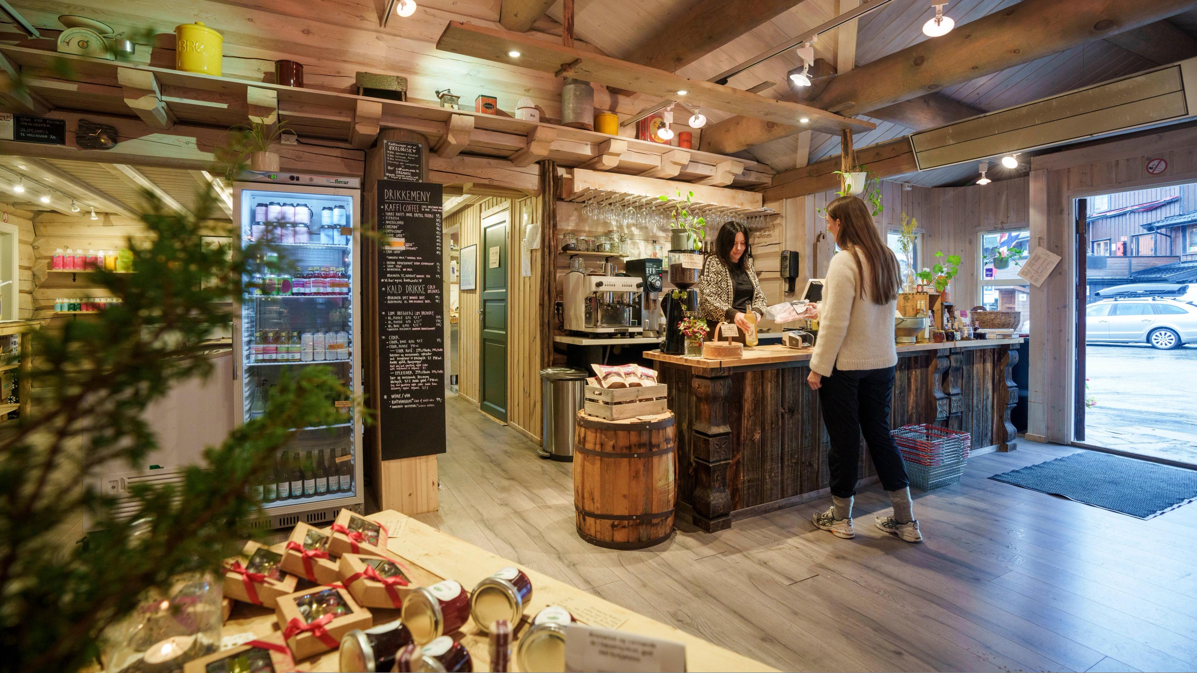 A woman buying local products in a food shop.