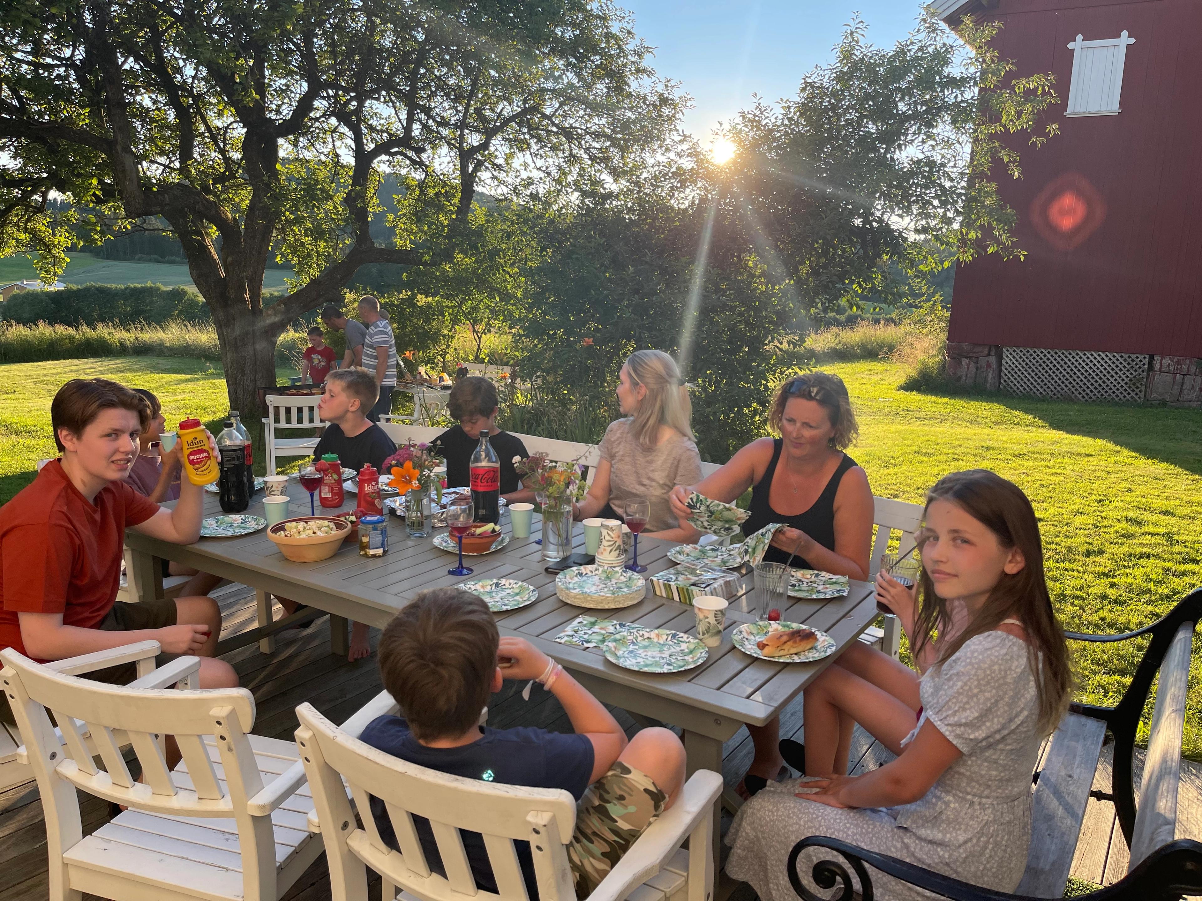 An extended family enjoying a meal at a farm holiday