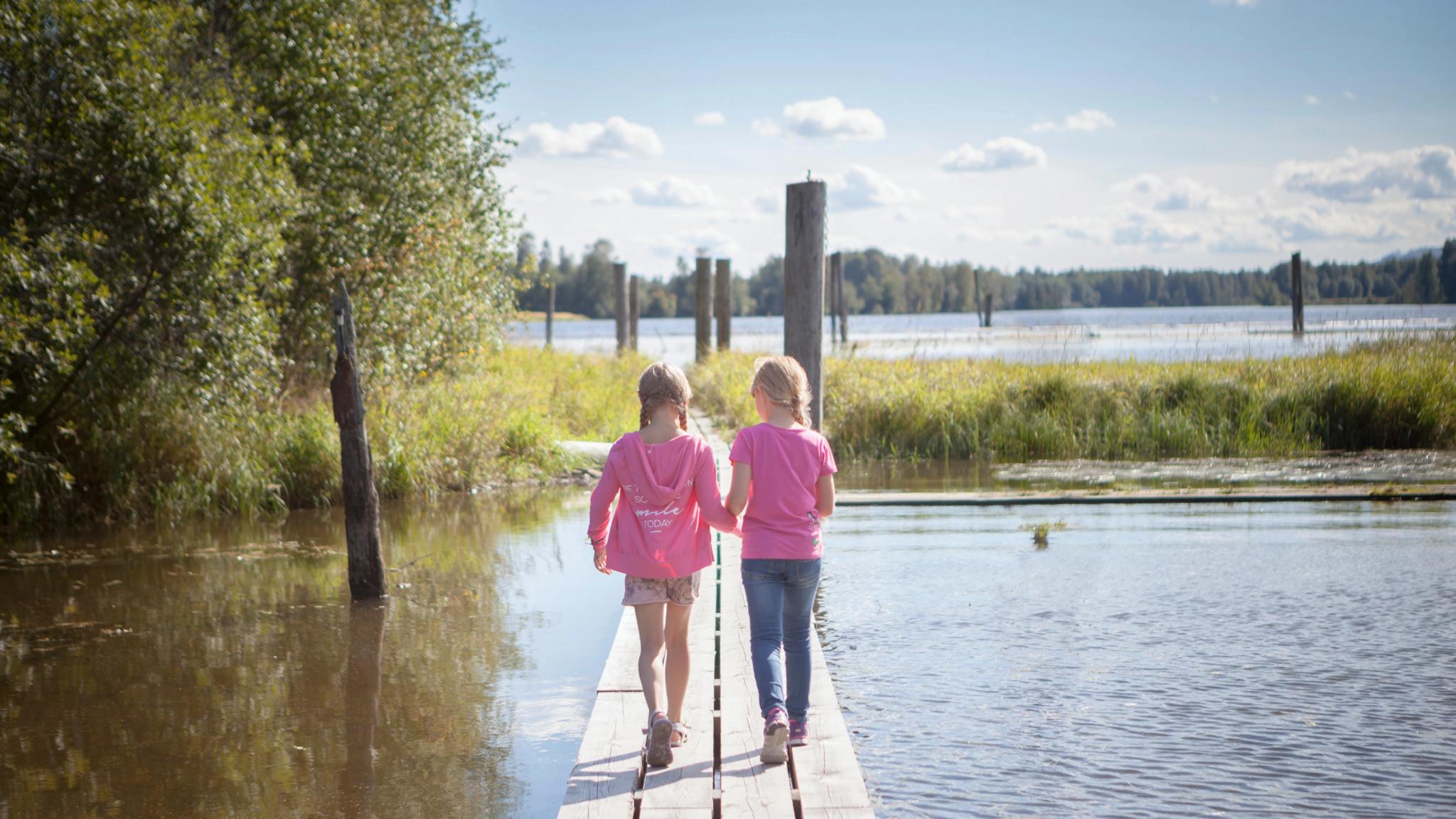 Two girls walking at Fetsund lenser at Glomma river, Eastern Norway
