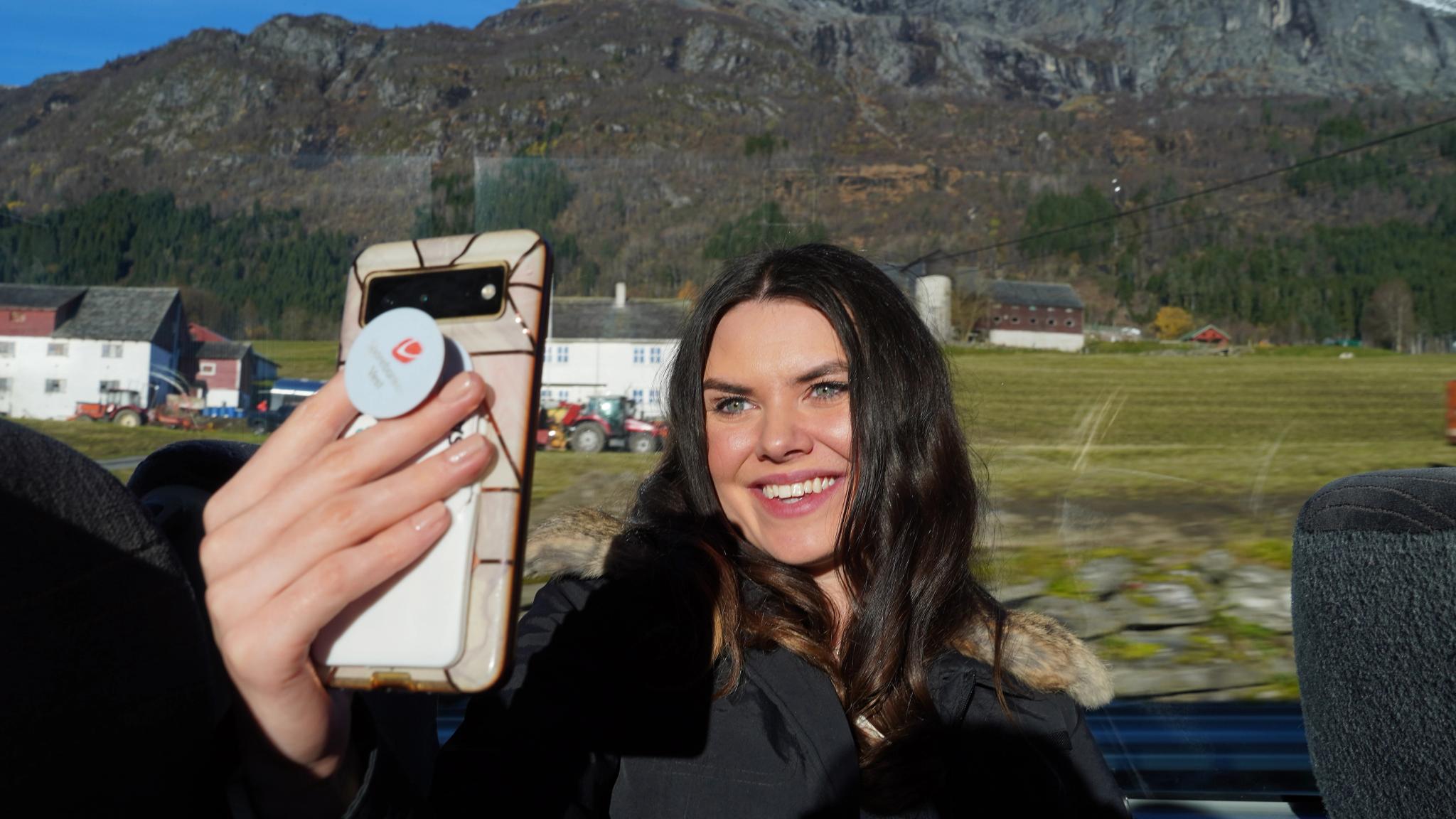 Woman taking selfie on a bus