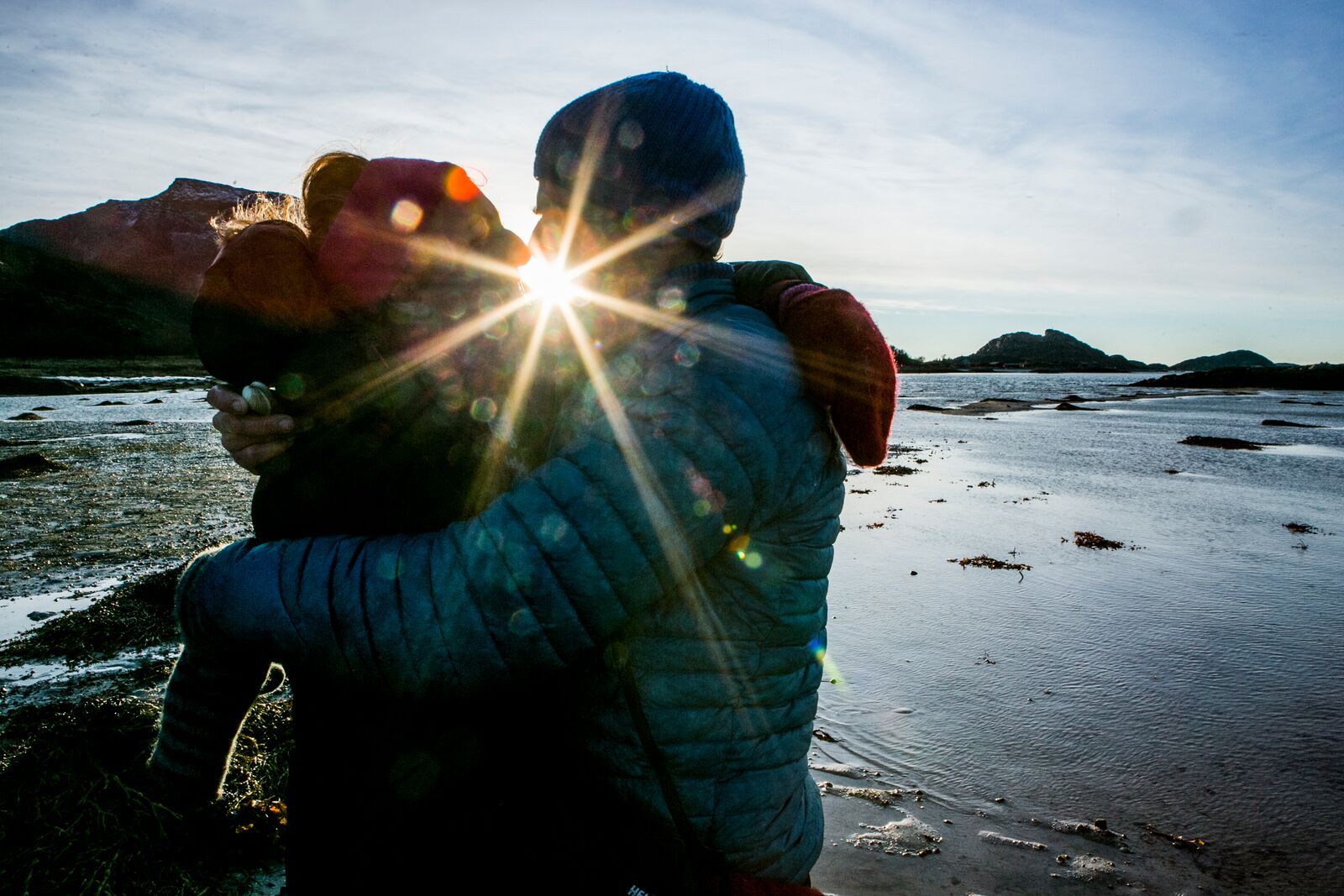Couple kissing while picking cockles