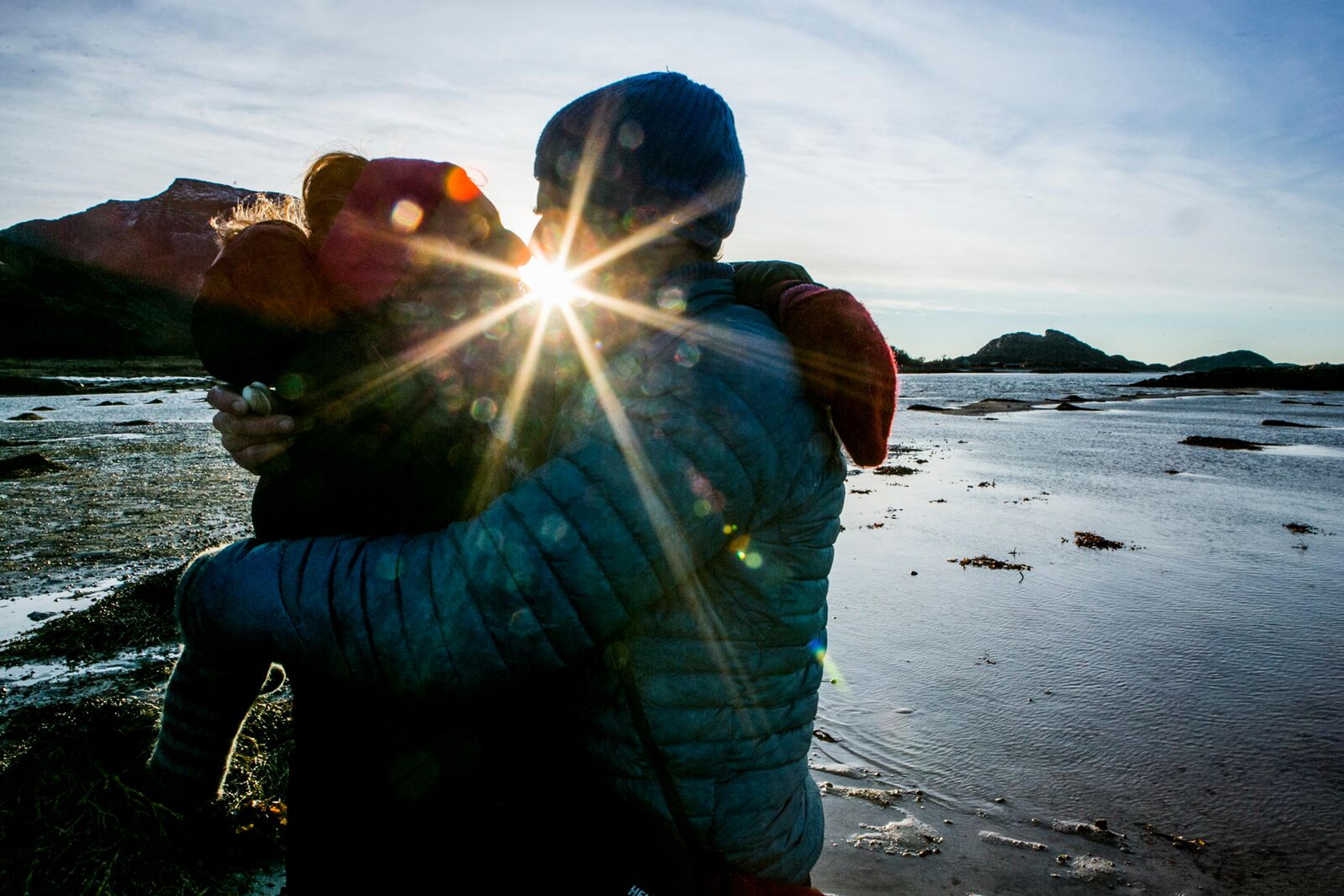 Couple kissing while picking cockles