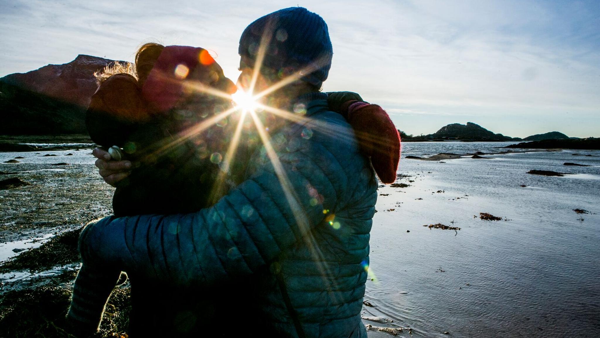 Couple kissing while picking cockles
