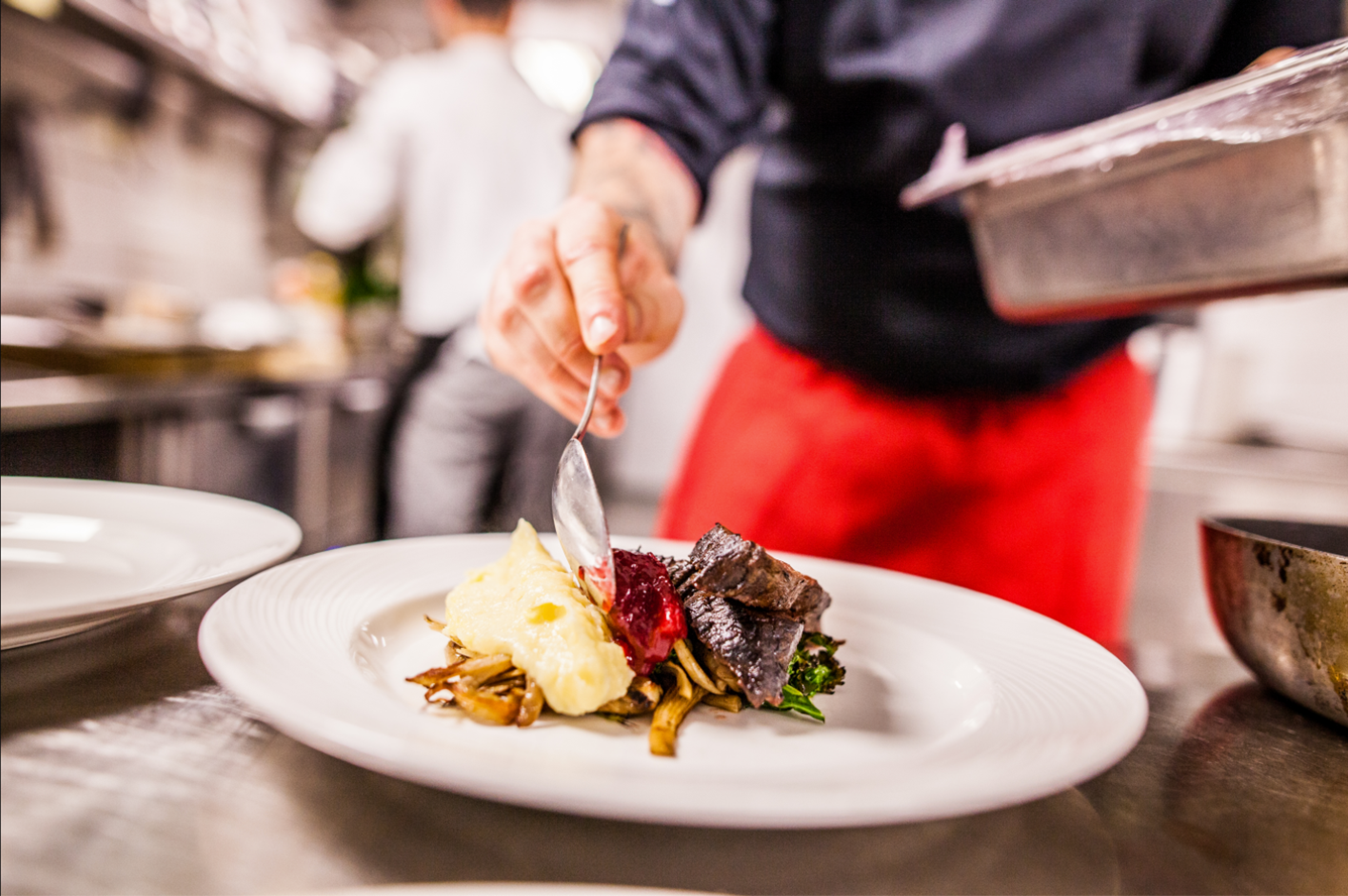 Chef prepares food on a plate