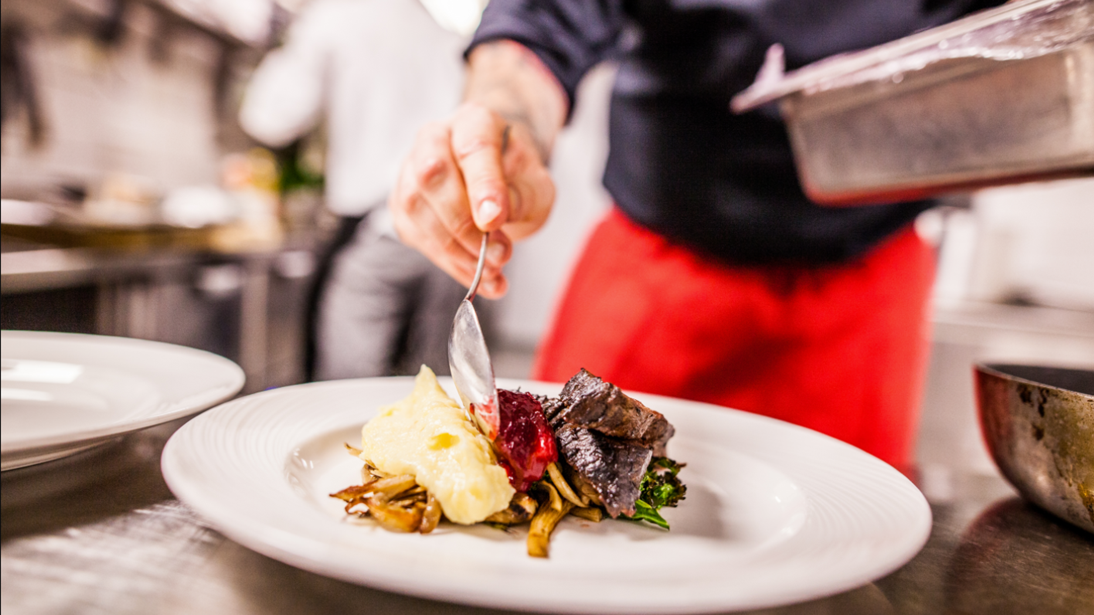 Chef prepares food on a plate