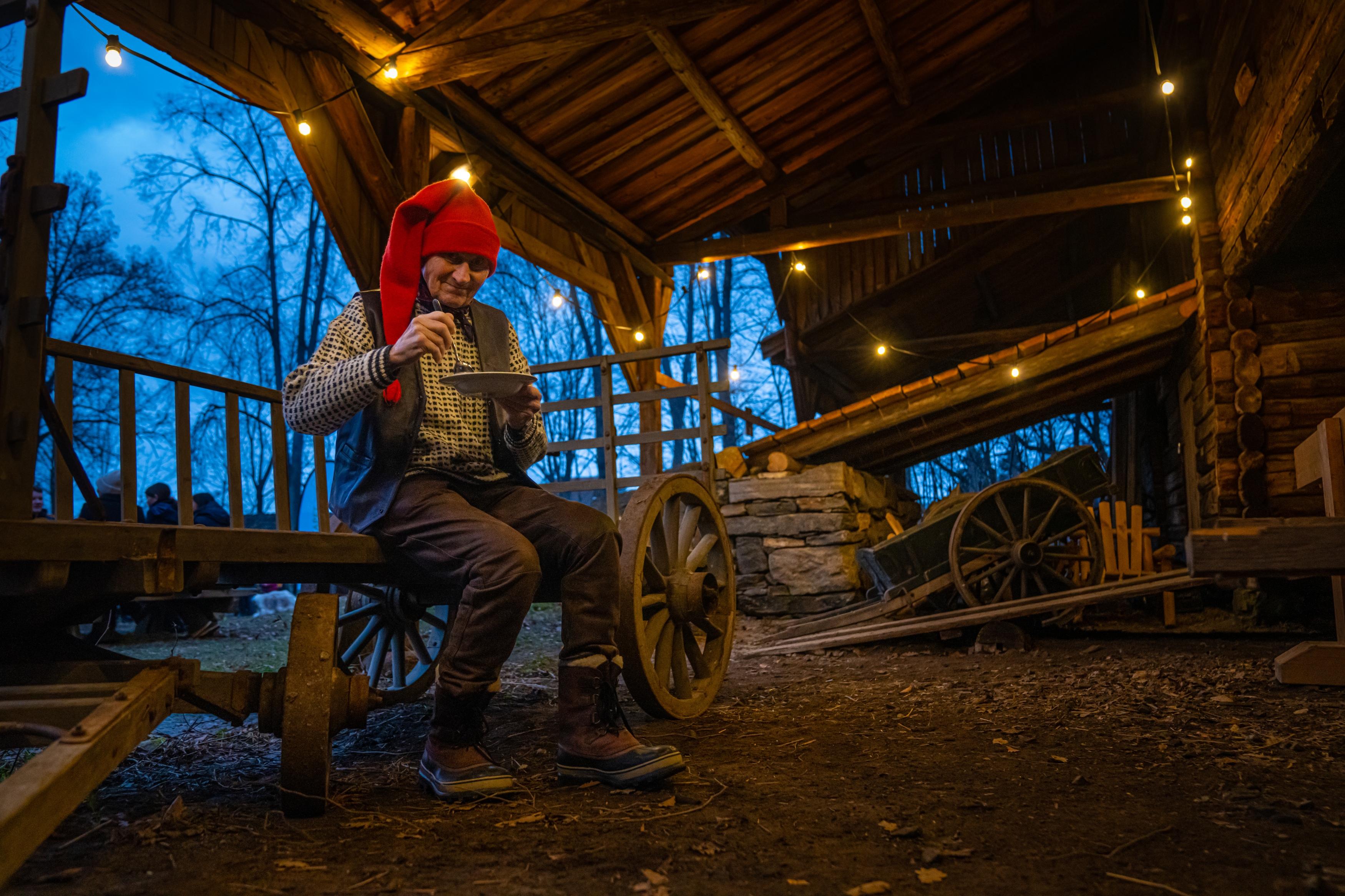 The Norwegian Santa is eating porridge at the Christmas market in Norsk Folkemuseum in Bygdøy, Eastern Norway