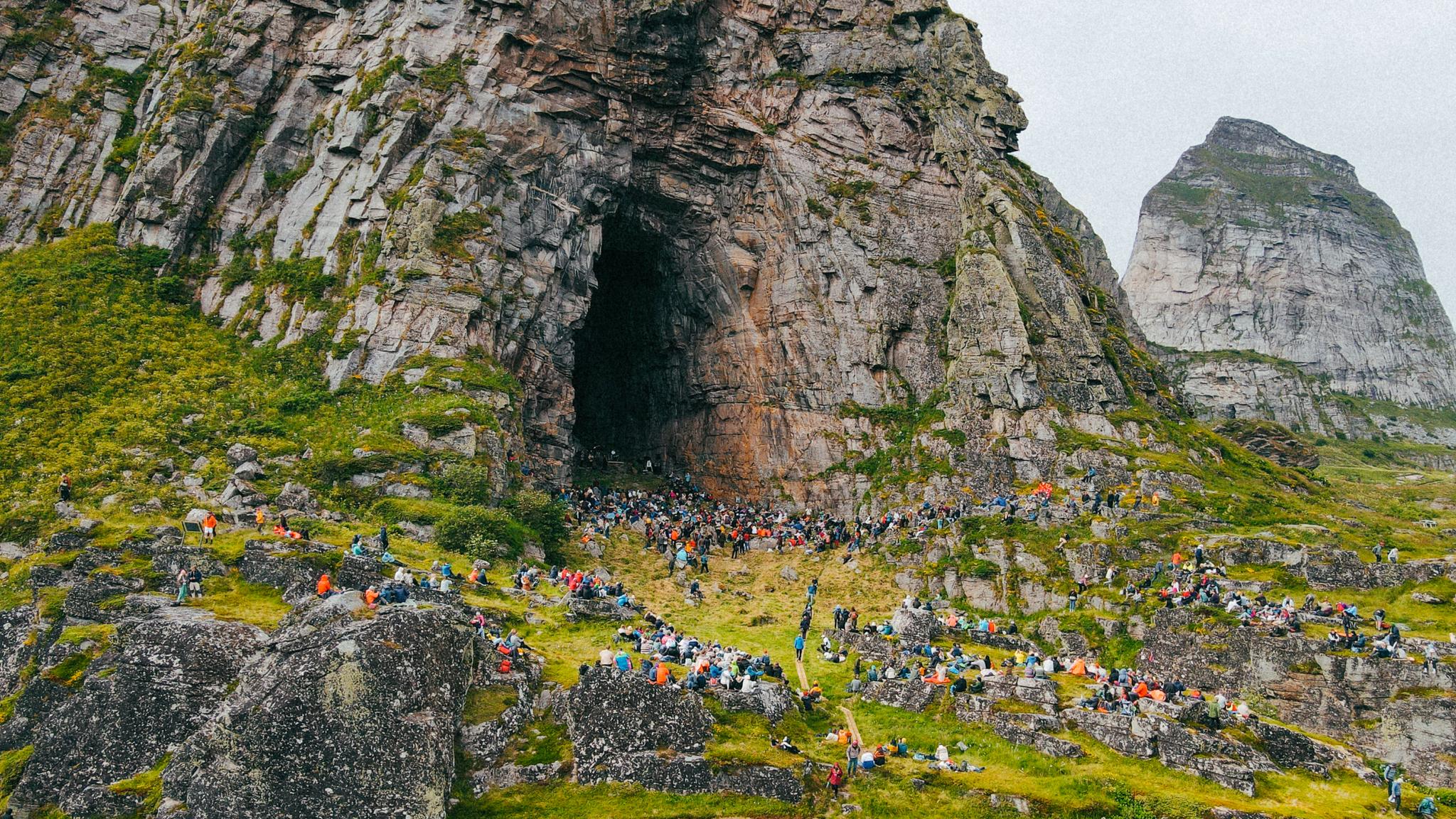 People at a concert in the Kirkhelleren cave in Træna, Helgeland, Northern Norway