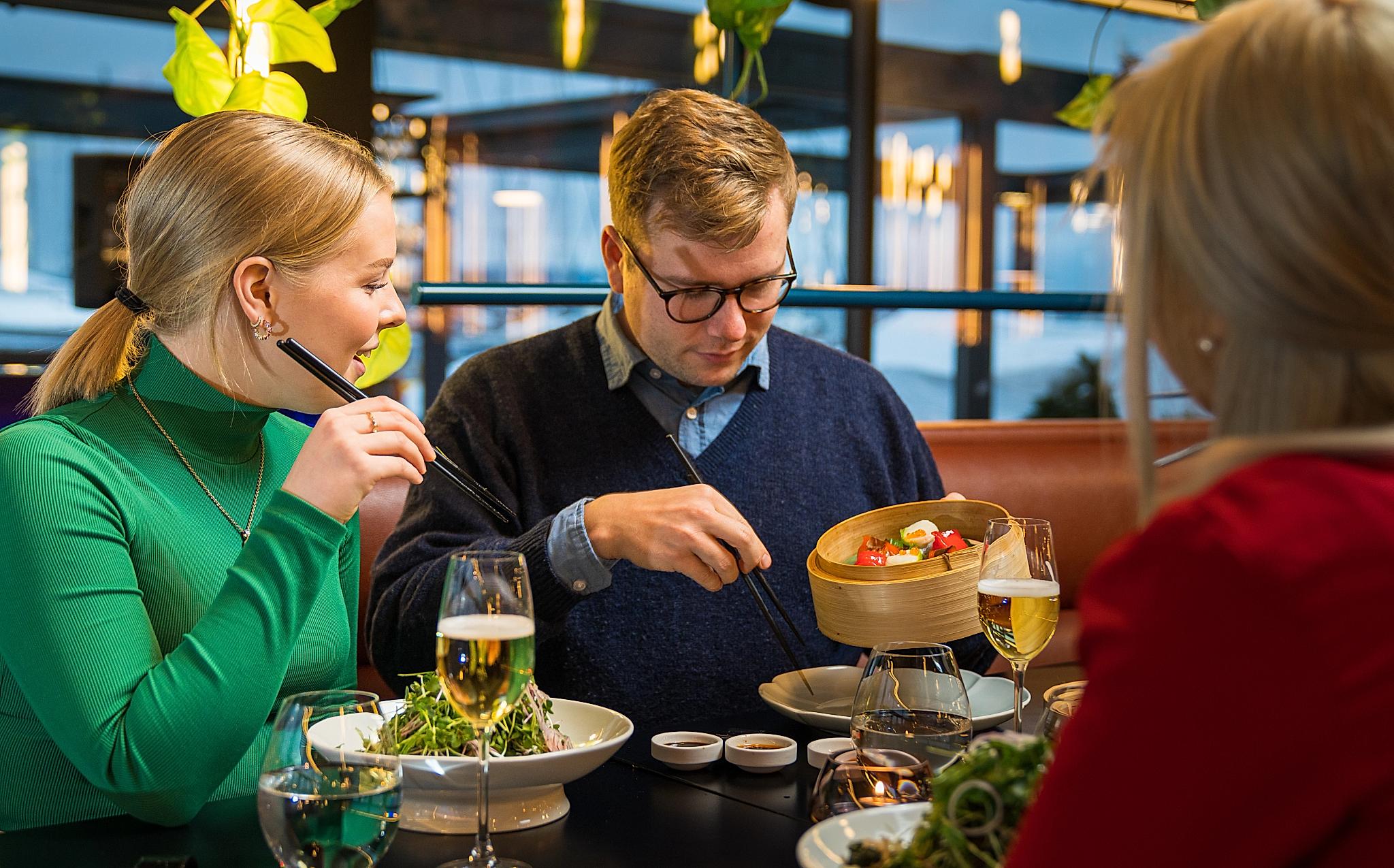 Friends enjoying dinner at a restaurant in Oslo