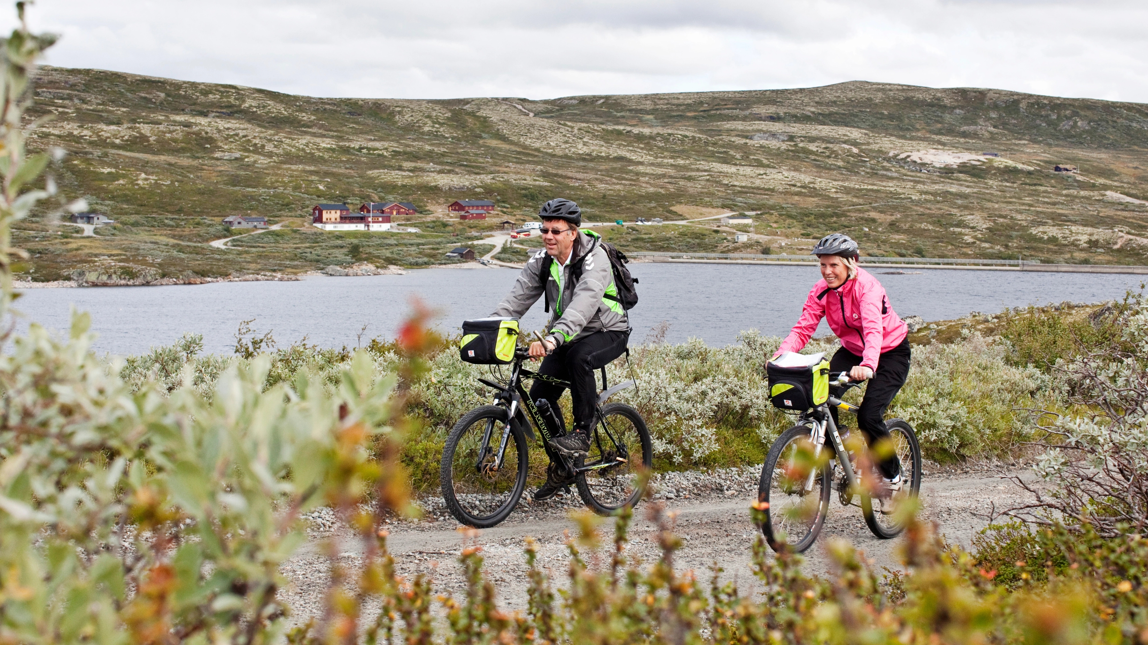 A couple is biking at the Hardangervidda mountain plateau