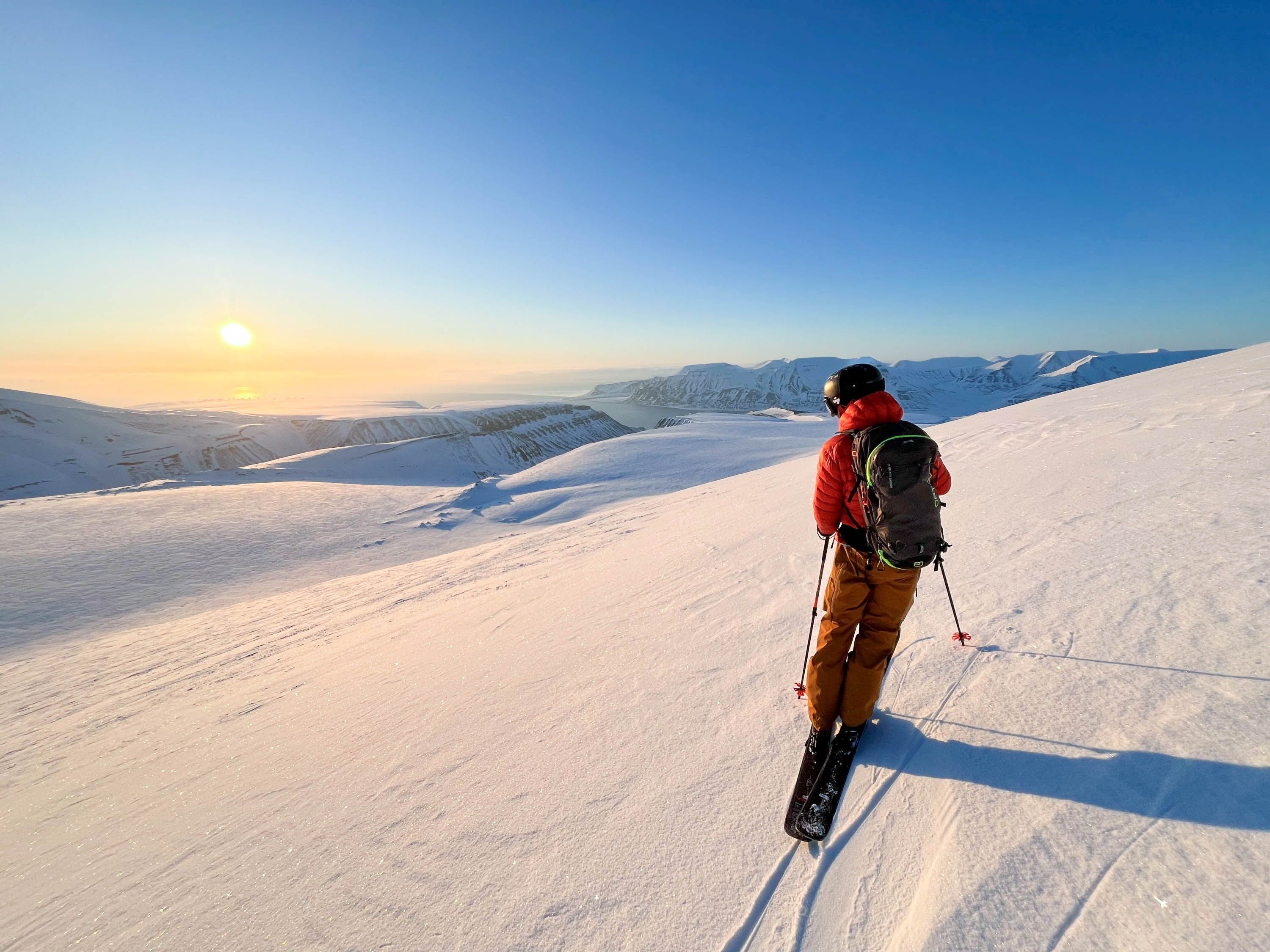 A person ski touring in sunny weather.