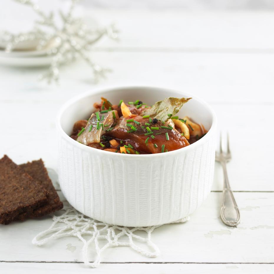 Traditional Norwegian pickled herring in tomato sauce in a glass jar