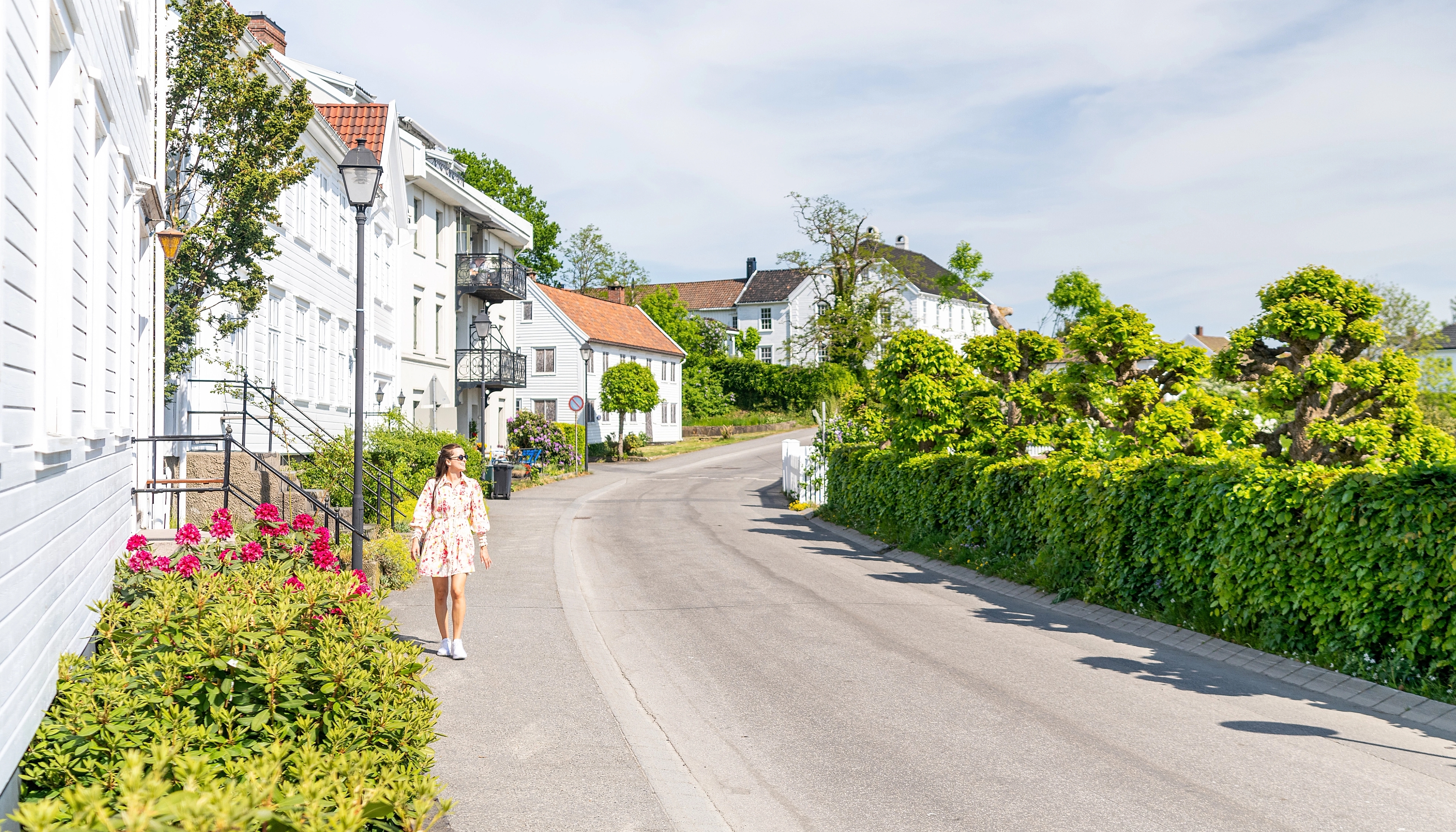 Girl walking in street by the ocean front in Lillesand, Southern Norway