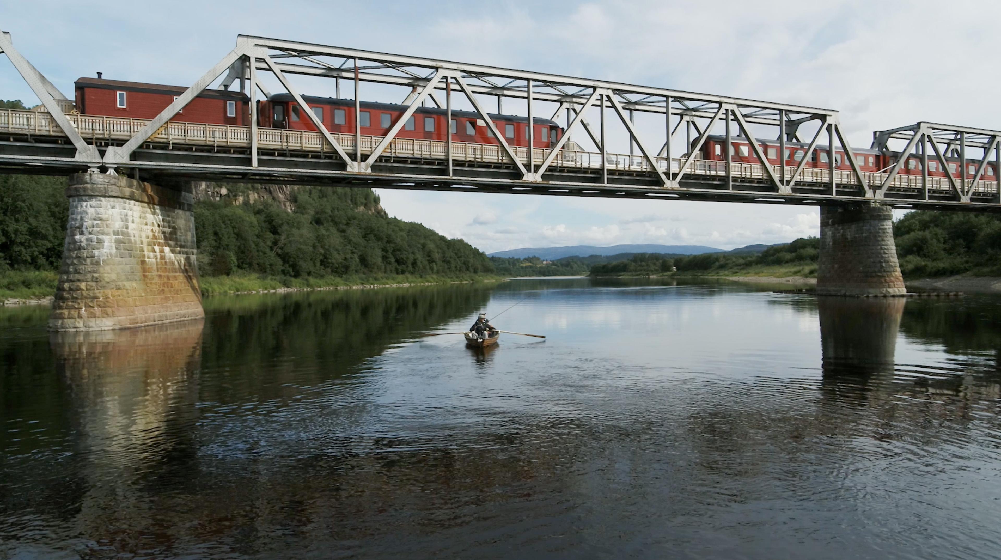 A fishing boat below the Namsen Salmon and Train Experience in Trøndelag, Norway