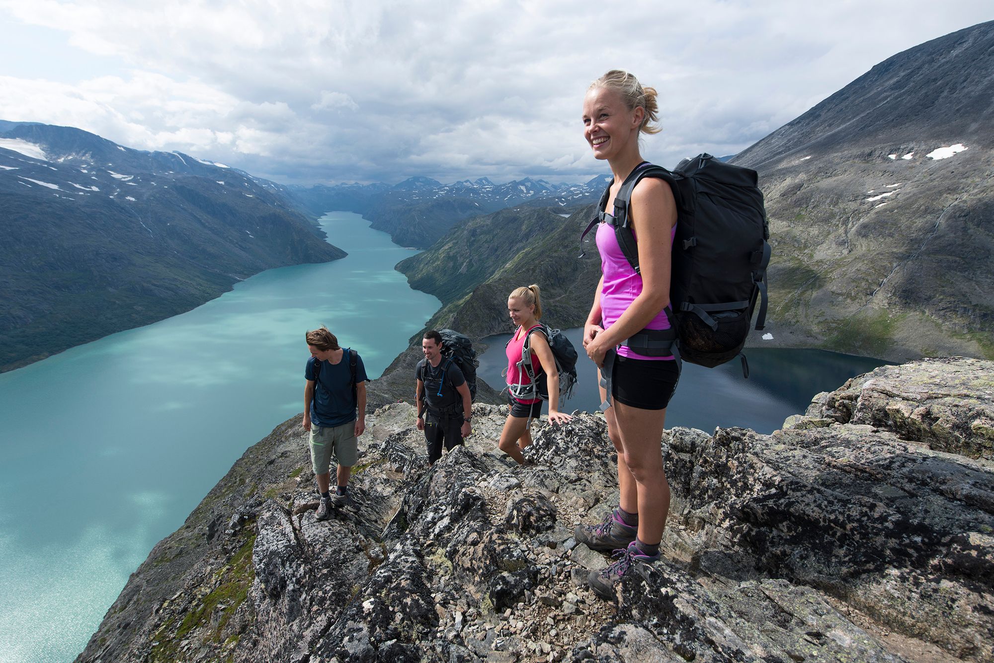 Friends are hiking the Besseggen ridge in Jotunheimen, Eastern Norway