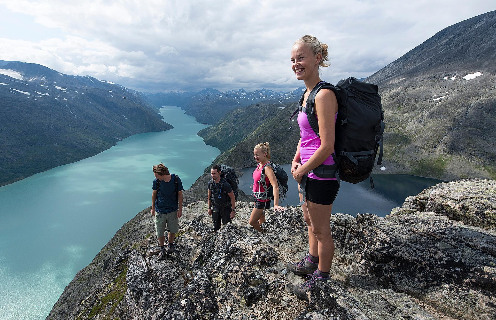 Friends are hiking the Besseggen ridge in Jotunheimen, Eastern Norway