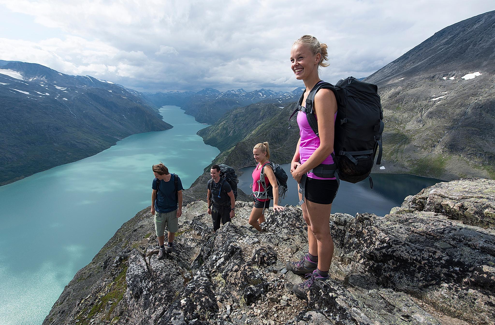 Friends are hiking the Besseggen ridge in Jotunheimen, Eastern Norway