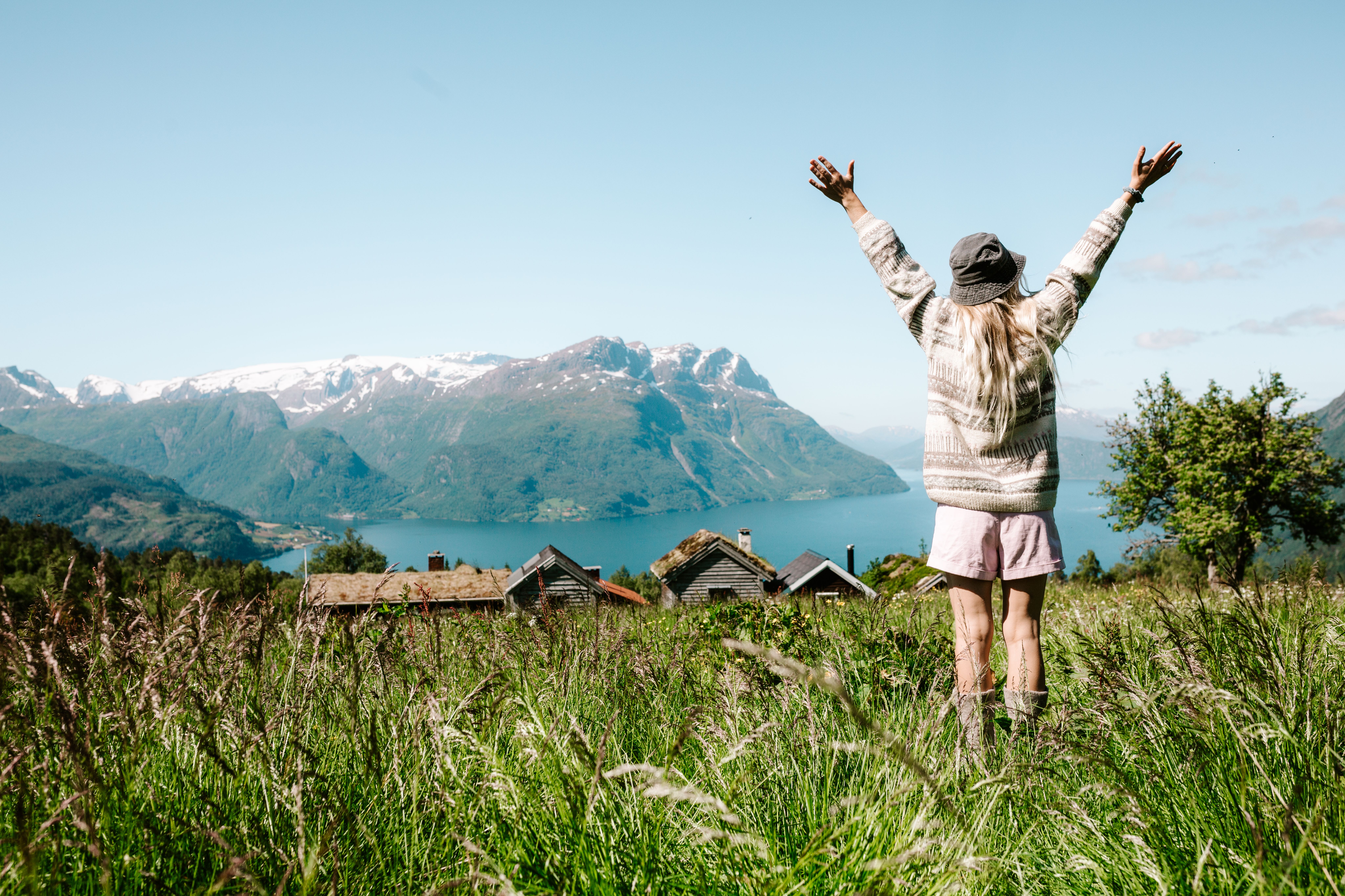 Woman on a mountain top over the fjord at Lotsstøylen in Nordfjord.