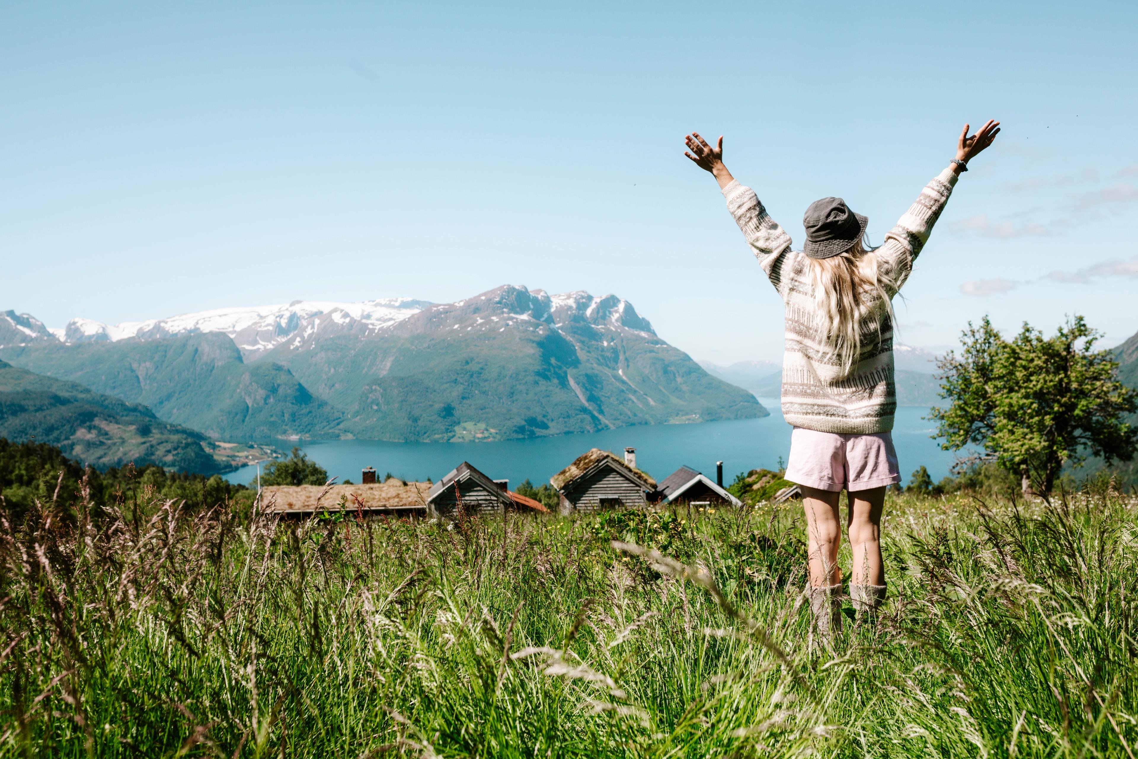 Woman on a mountain top over the fjord at Lotsstøylen in Nordfjord.