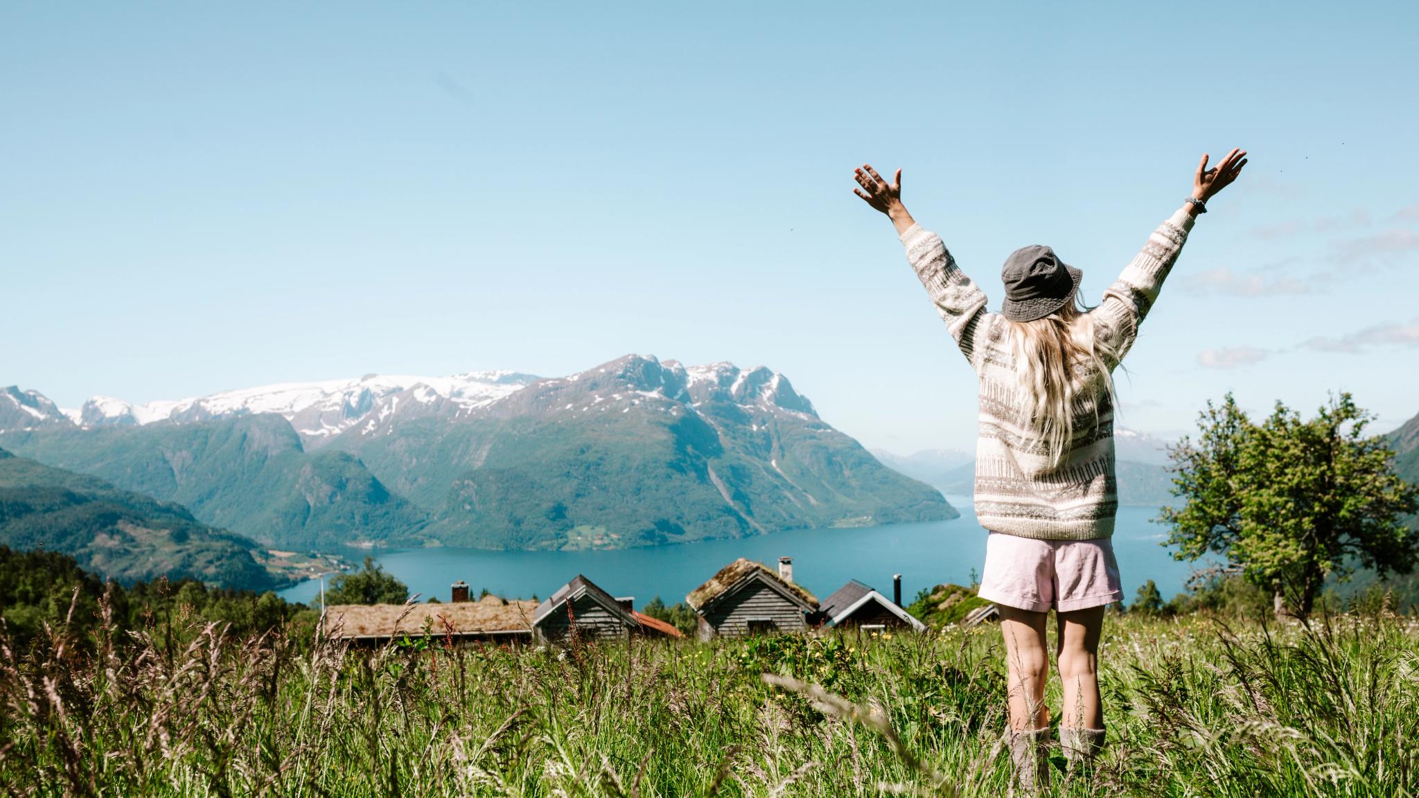 Woman on a mountain top over the fjord at Lotsstøylen in Nordfjord.