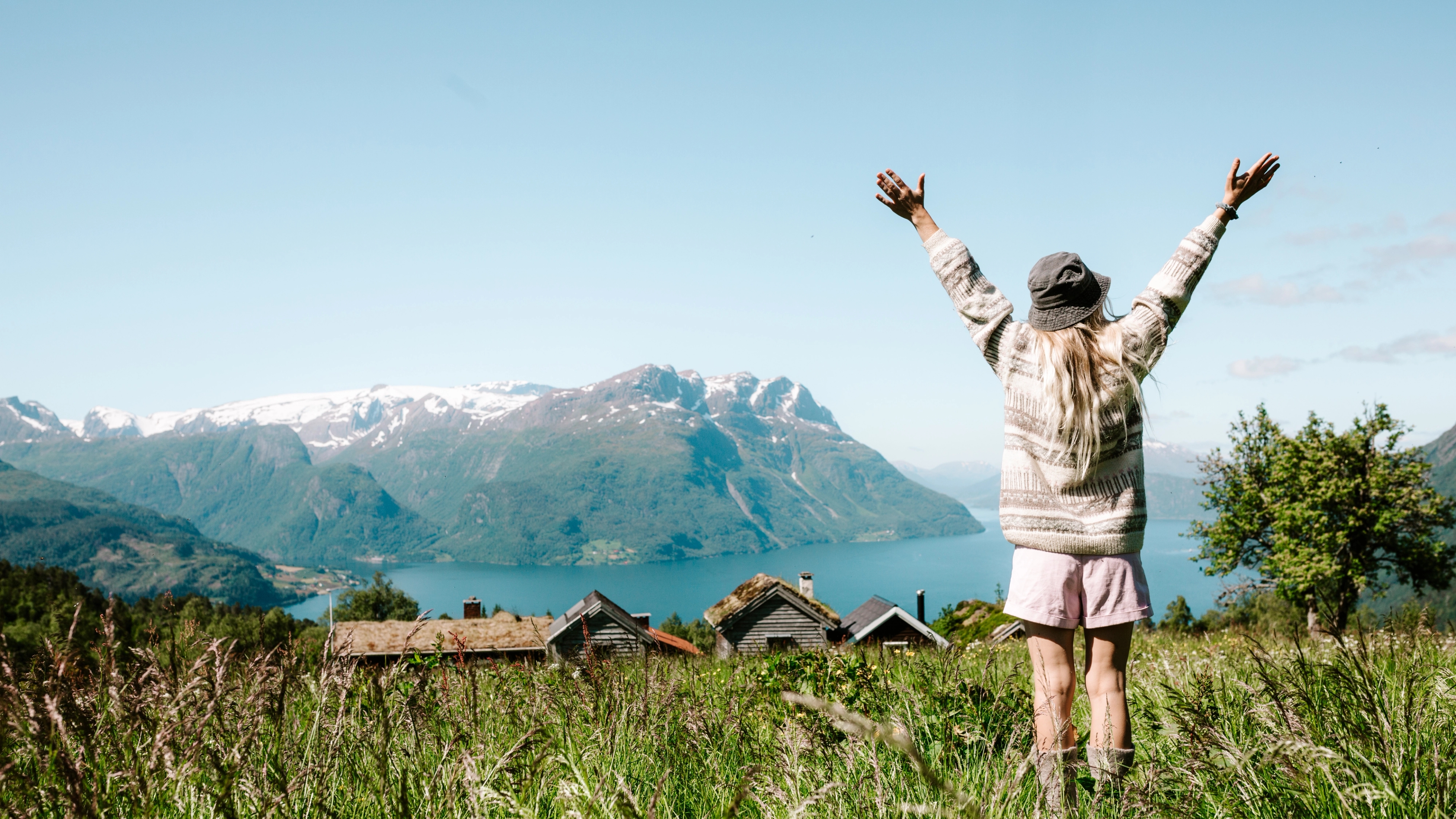 Woman on a mountain top over the fjord at Lotsstøylen in Nordfjord.