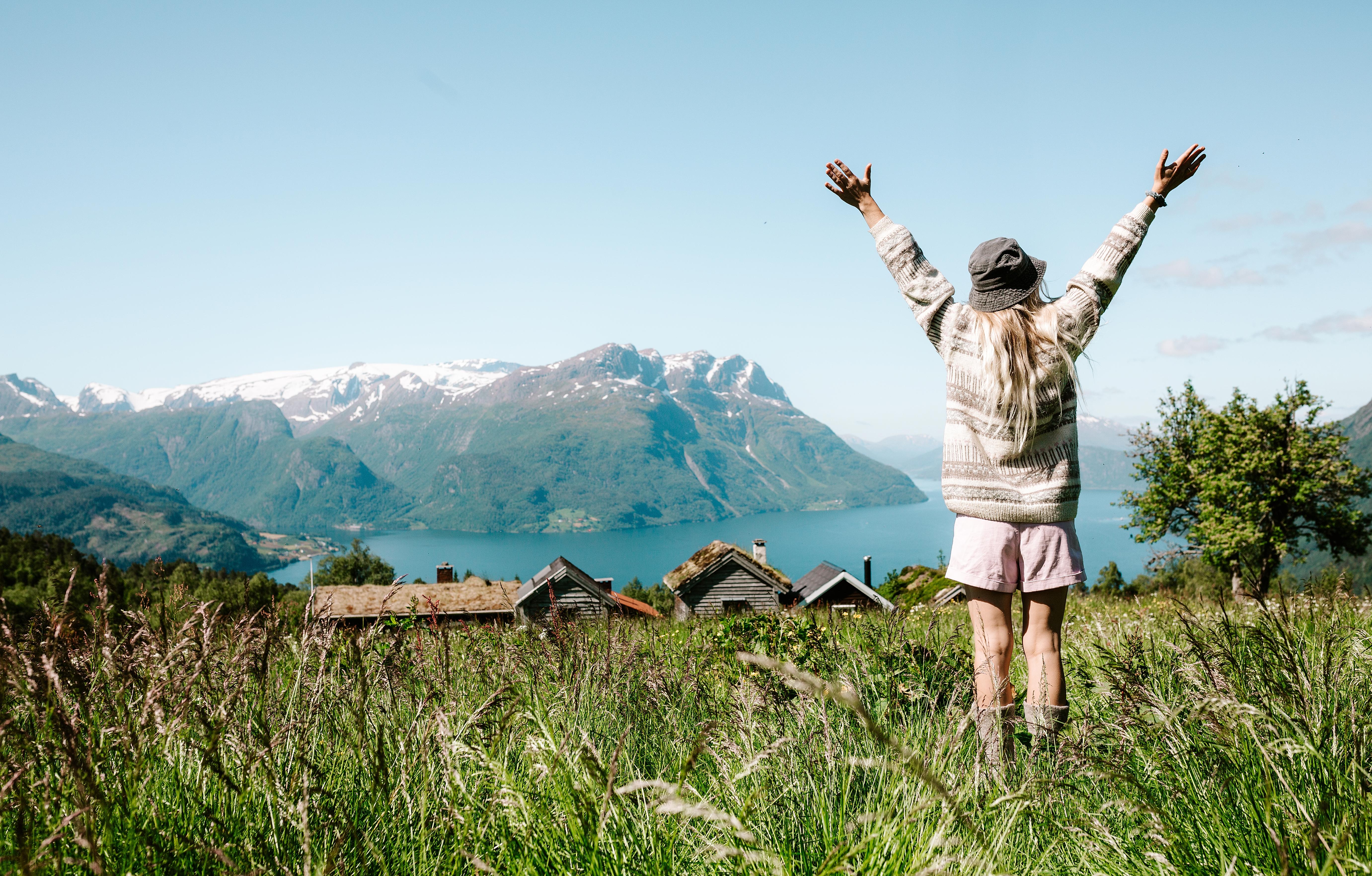 Woman on a mountain top over the fjord at Lotsstøylen in Nordfjord.