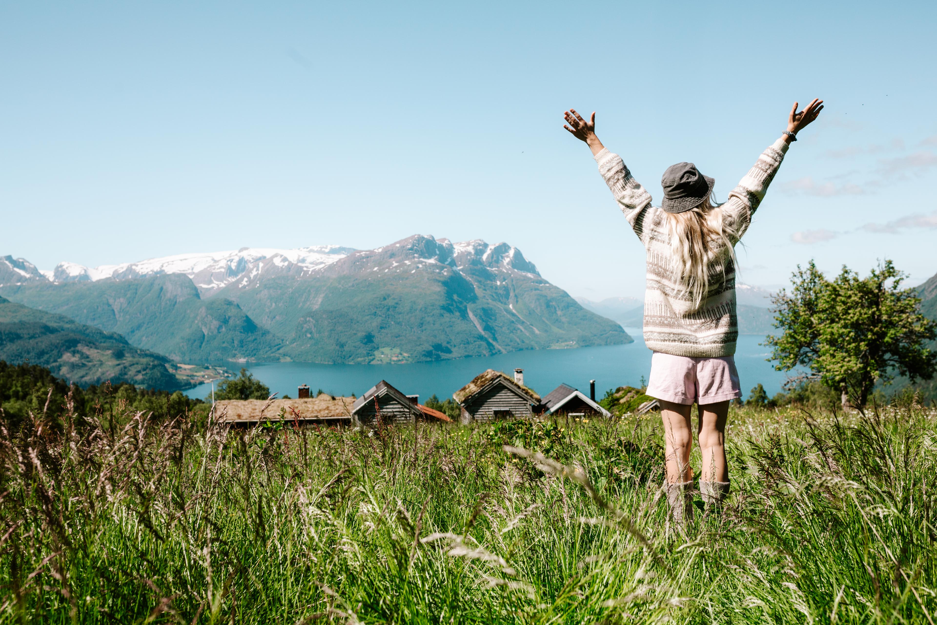 Woman on a mountain top over the fjord at Lotsstøylen in Nordfjord.