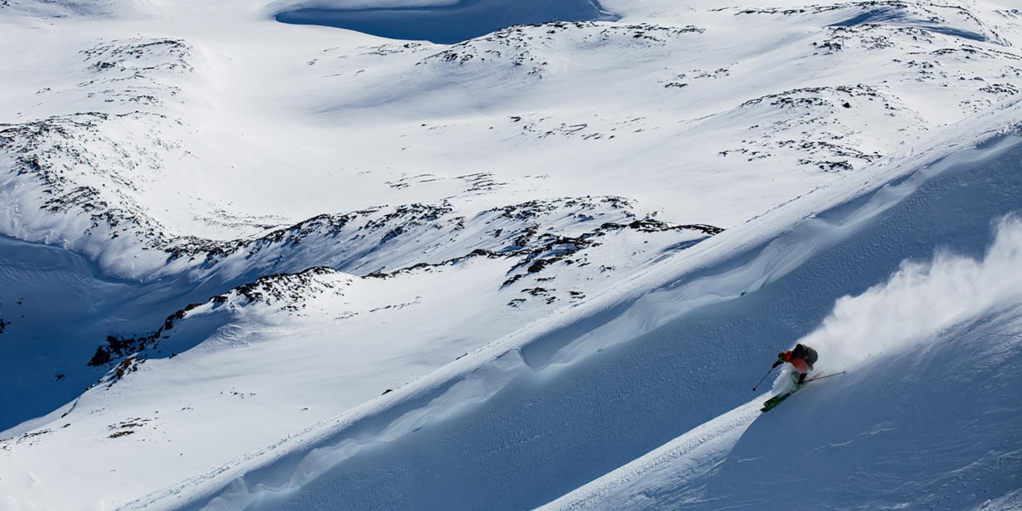 A person does off-piste skiing in an empty snow-clad landscape in Jotunheimen, Eastern Norway