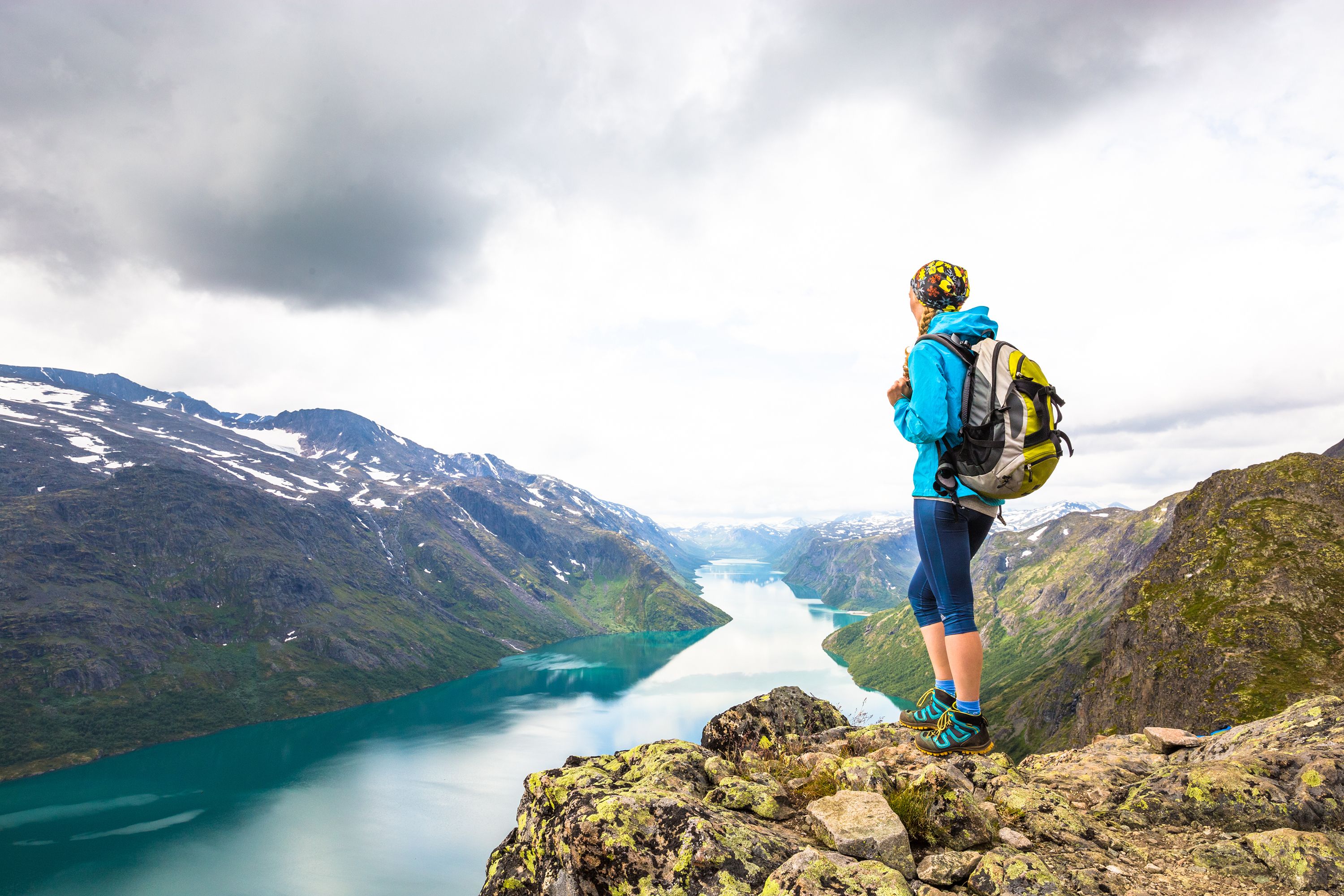 Una mujer disfruta de las vistas del lago Gjende desde lo alto de Besseggen, en Jotunheimen, Este de Noruega.